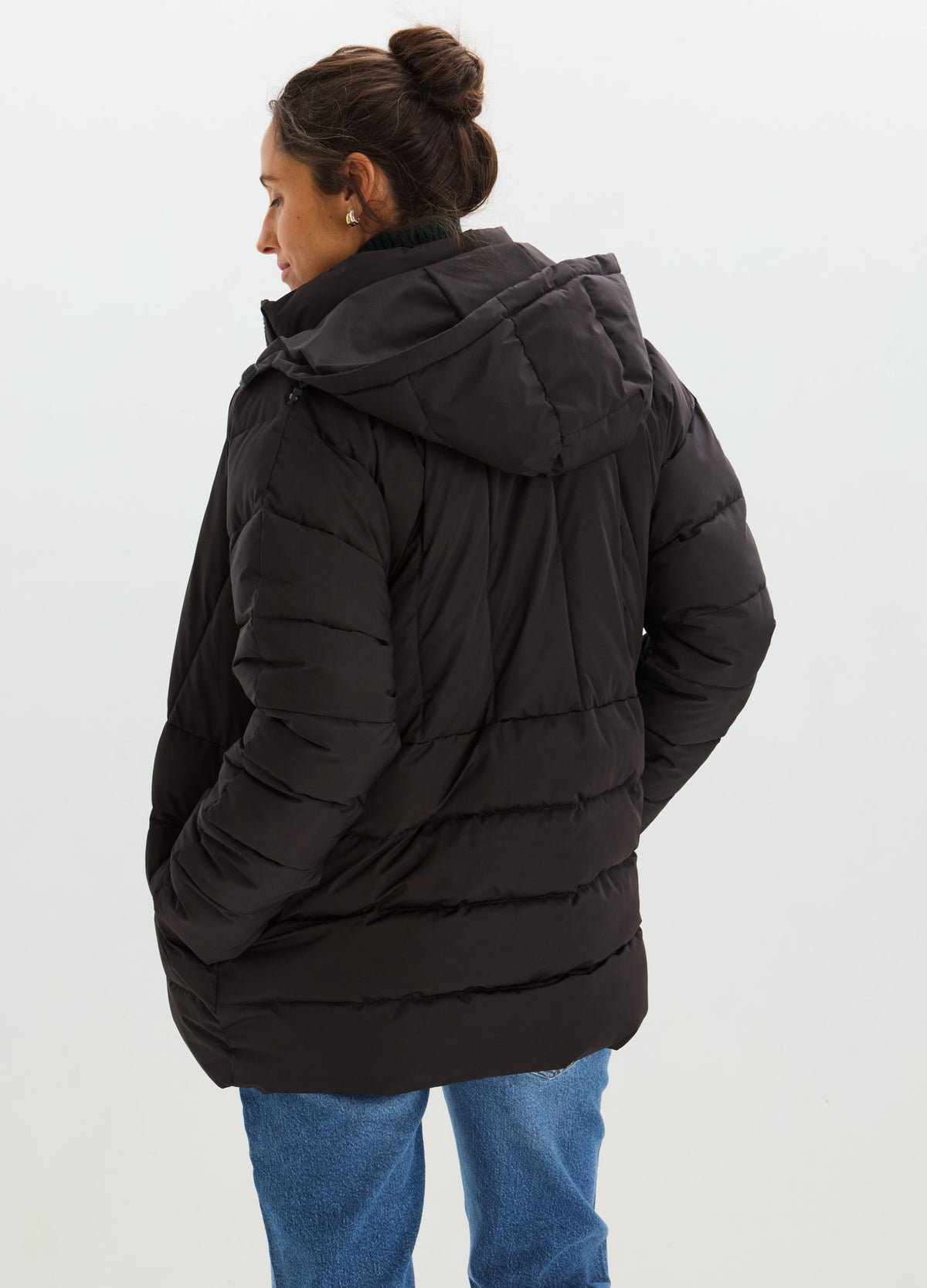 Black quilted puffer jacket with a high collar, hood, and hip-length fit, shown from the back.