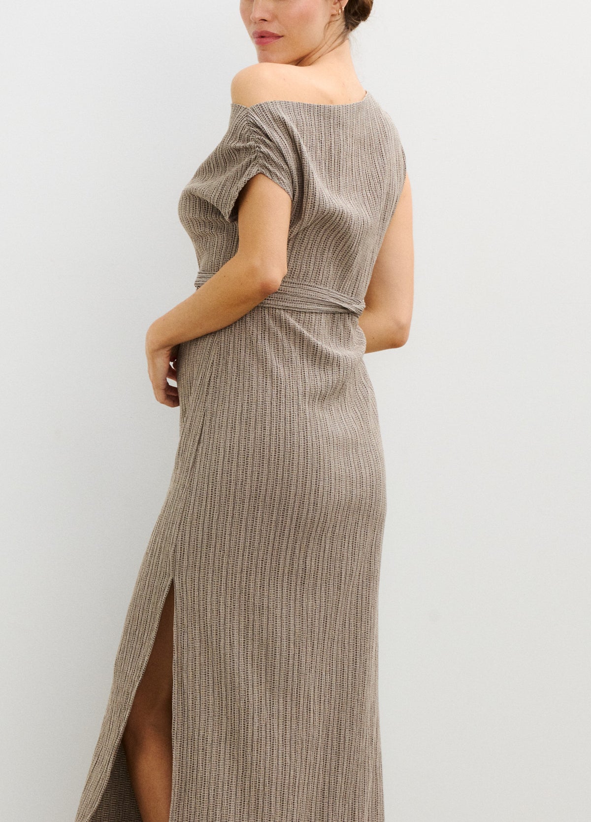 Taupe ribbed knit maternity dress with off-shoulder neckline and side slit, fitted for pregnant shape.