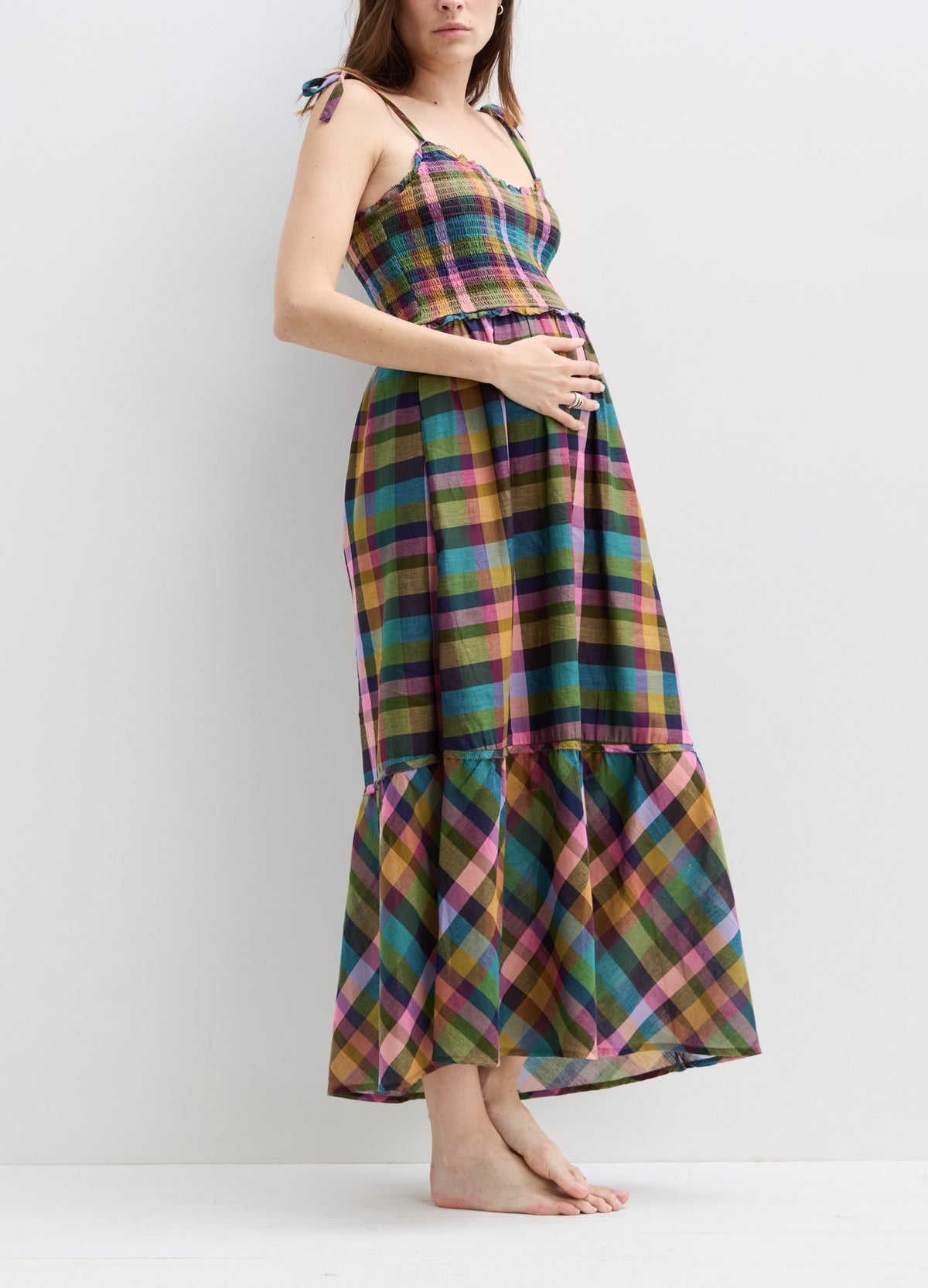 Colorful plaid maternity maxi dress with adjustable shoulder ties and a gathered hem.