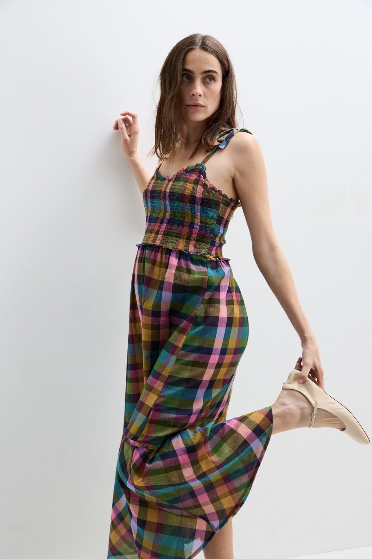 Sleeveless maternity maxi dress with multicolor plaid pattern and adjustable shoulder ties.