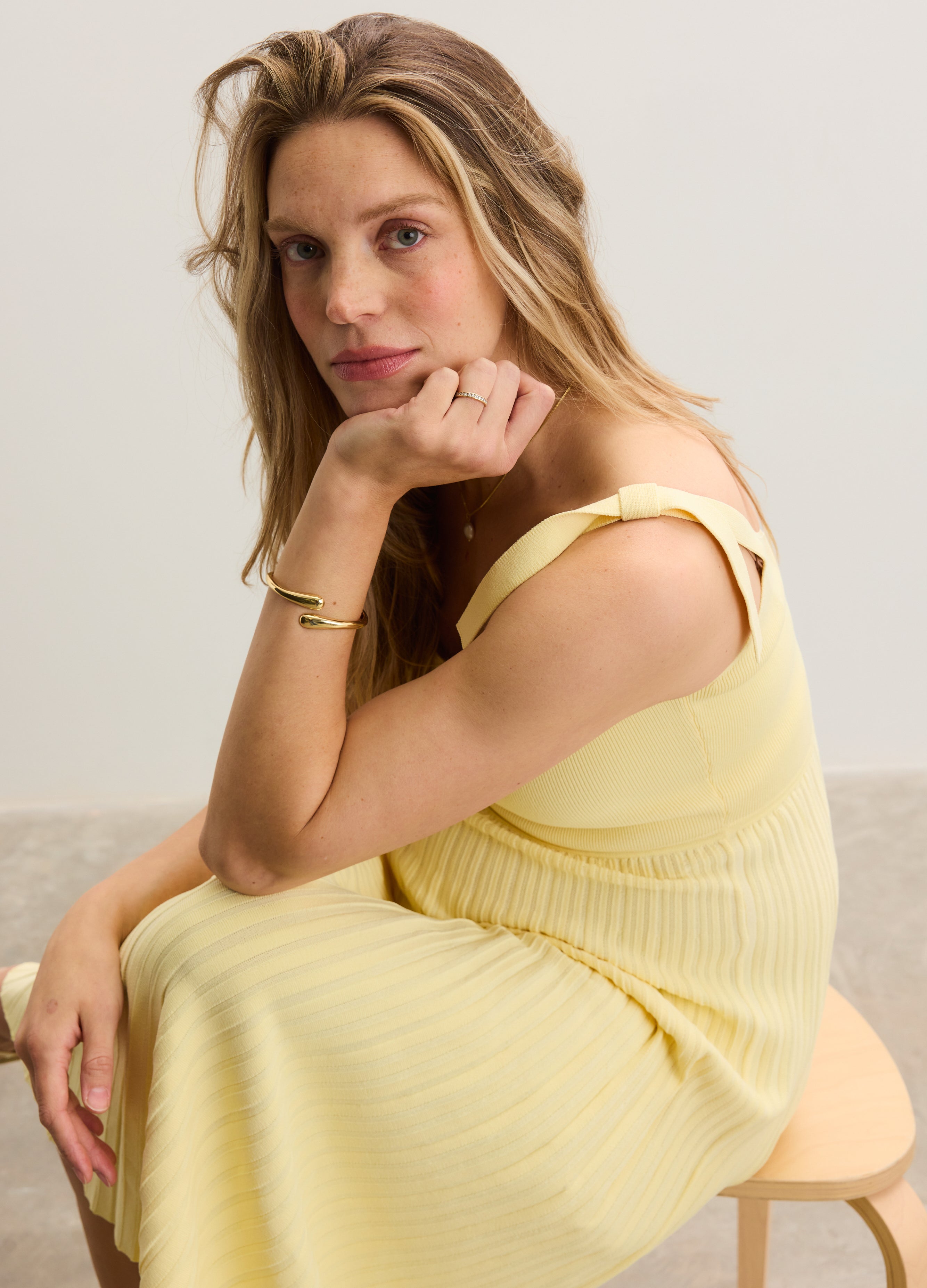 Soft yellow ribbed maternity dress with thick straps and a fitted bodice, designed for pregnant comfort.