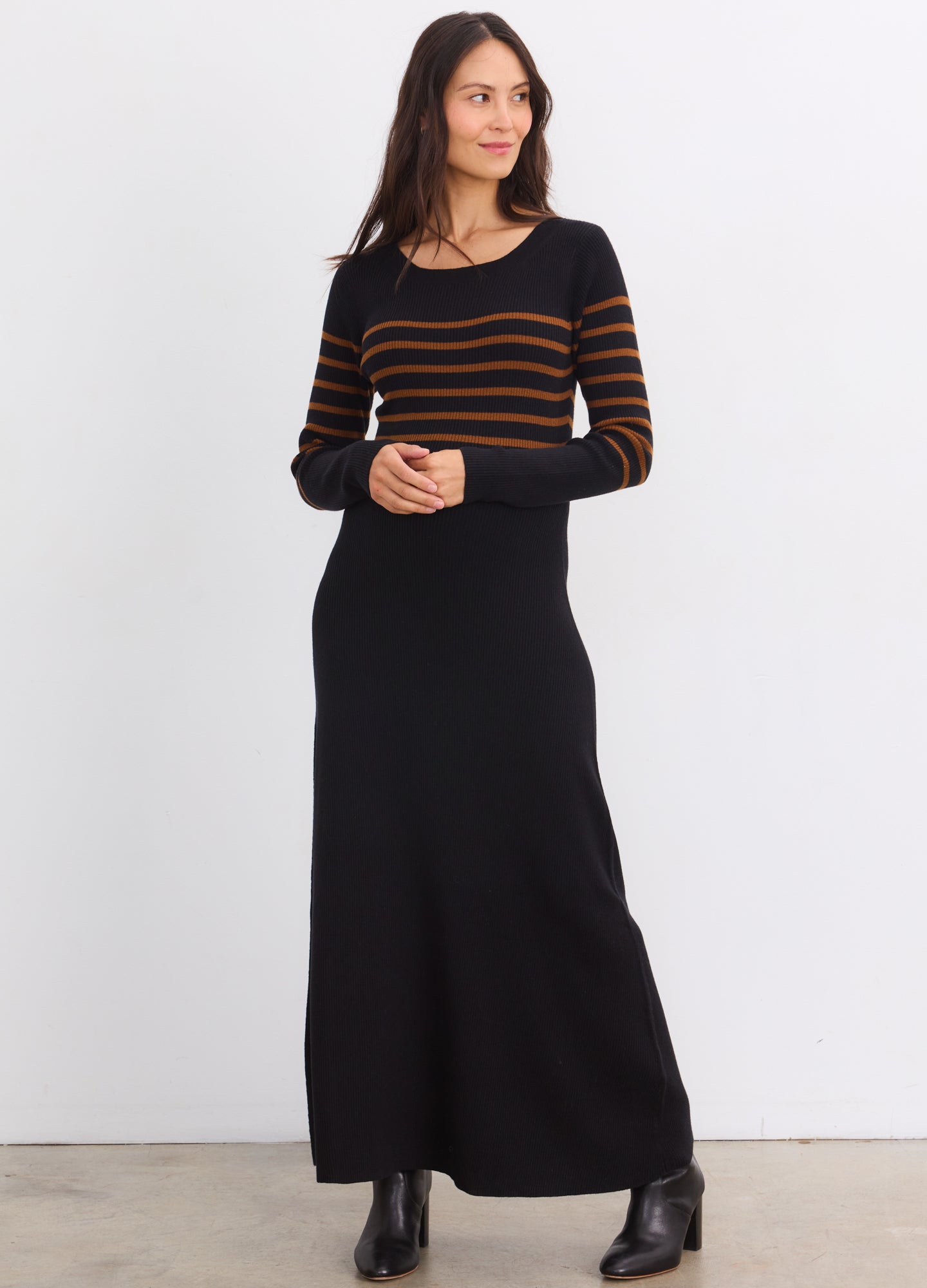 Black and acorn striped maternity sweater dress with long sleeves, fitted top, and flowing skirt for pregnant women.