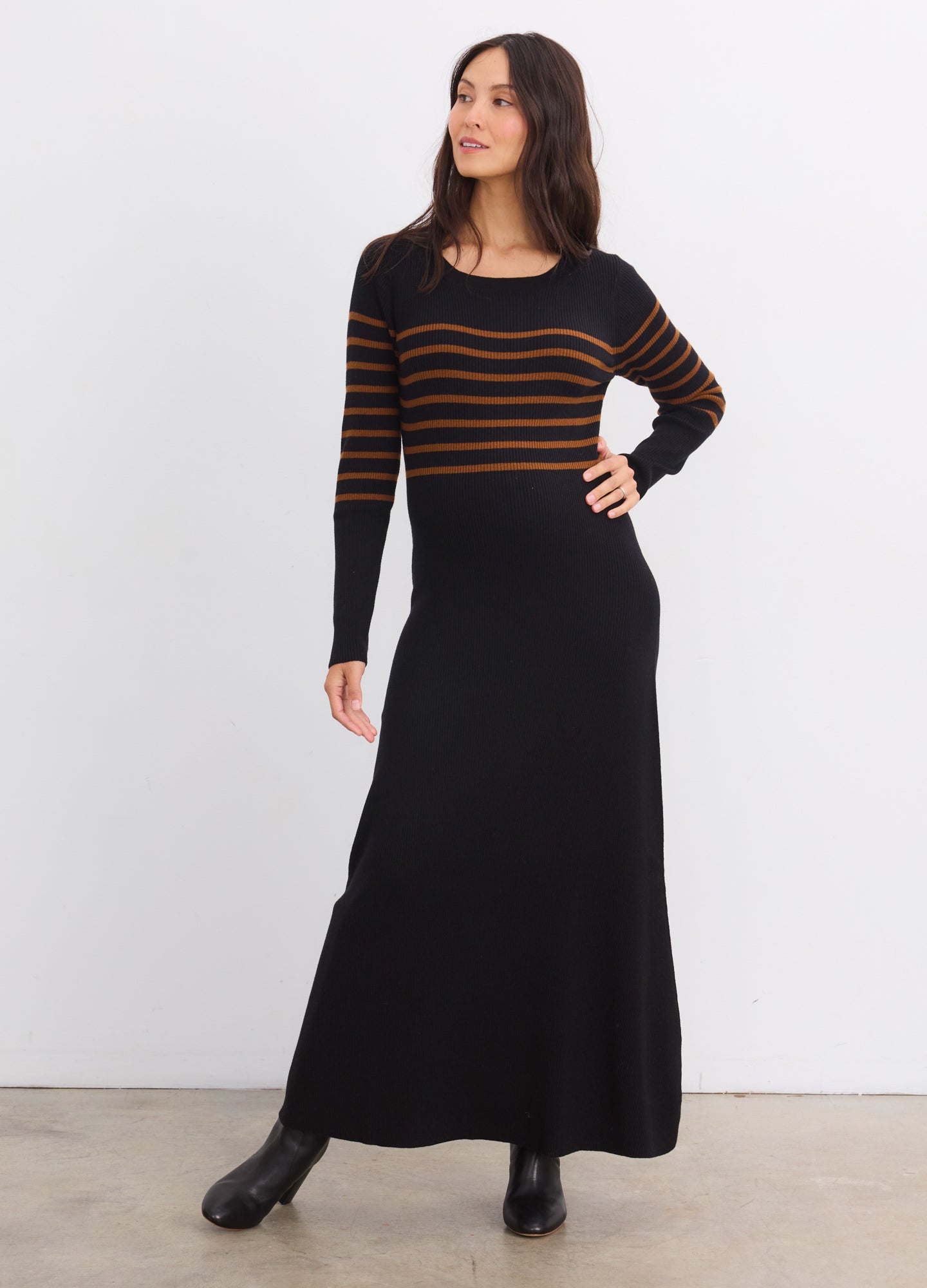 Black maternity sweater dress with brown stripes on top, long sleeves, and fitted pregnant silhouette.