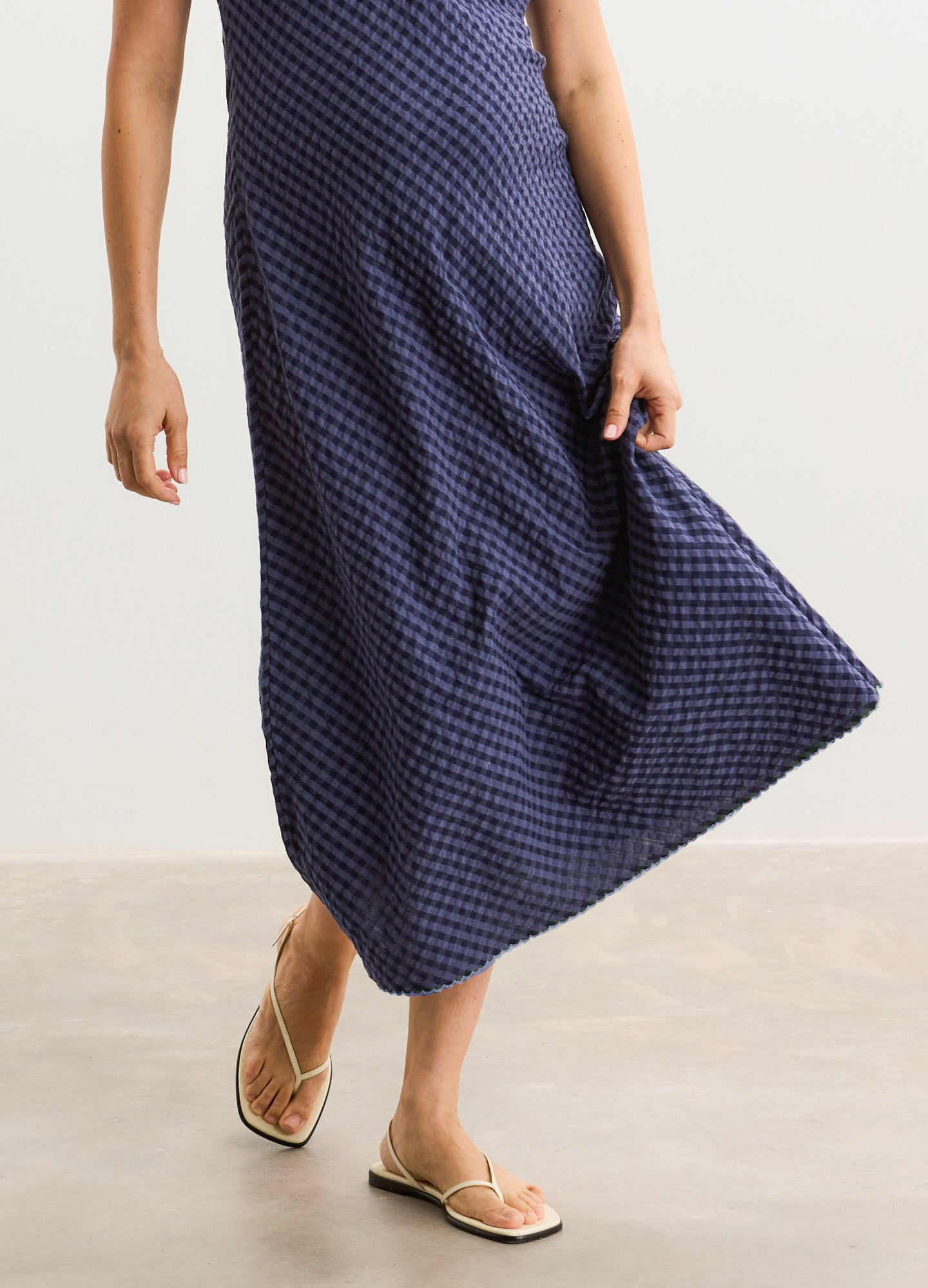 Navy blue midi maternity dress with textured pattern and flowing A-line silhouette.