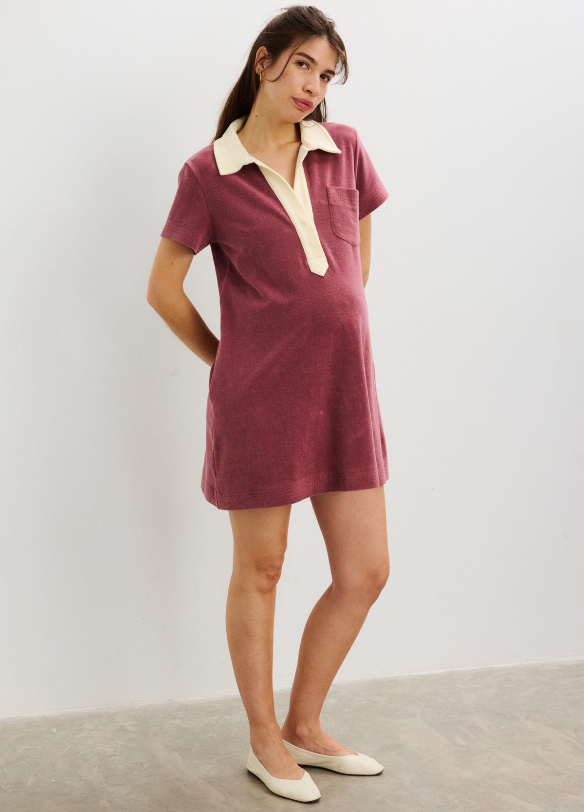 Short-sleeve maternity dress in dusty rose with contrasting cream collar and button placket, above-knee length.