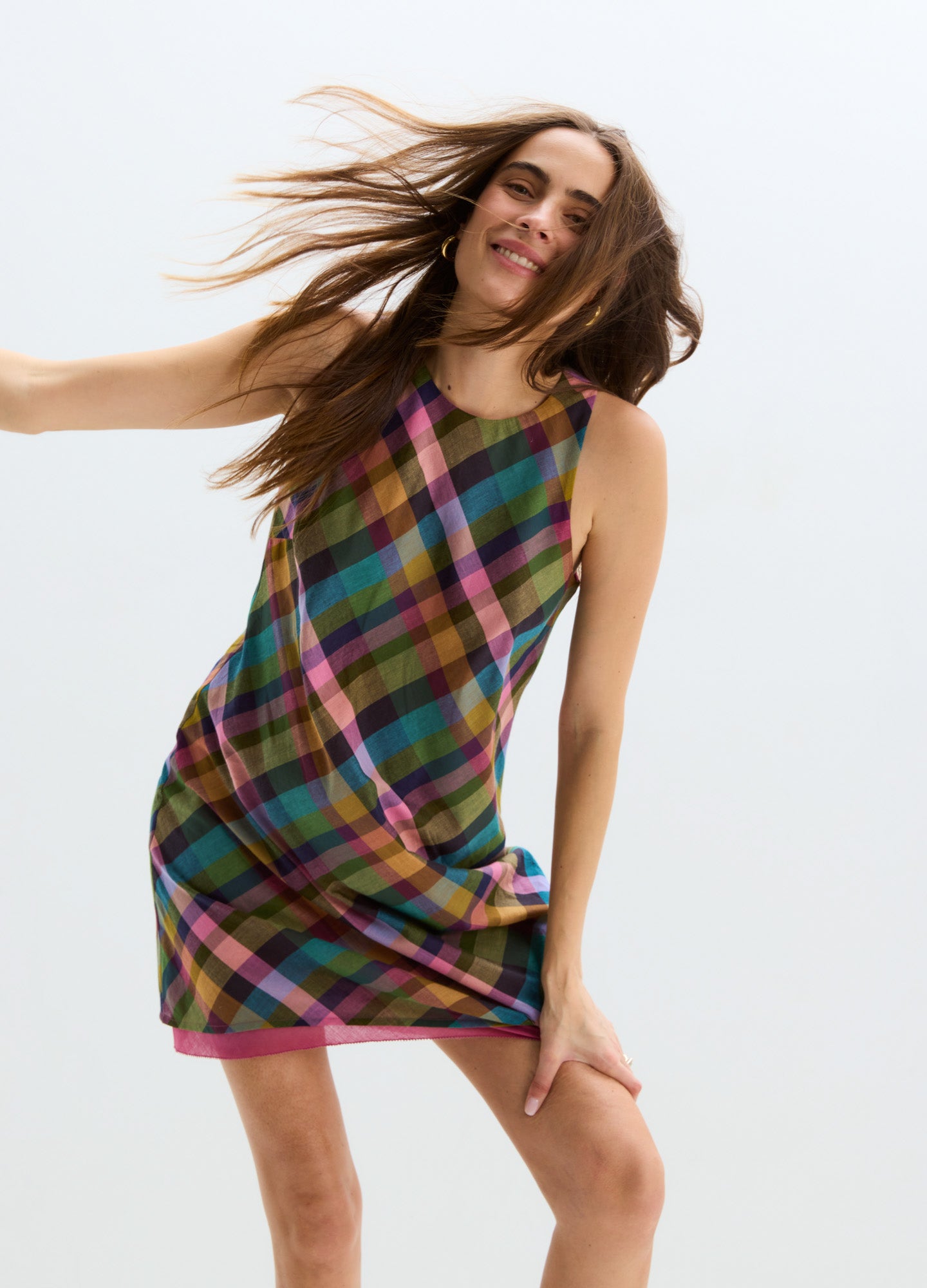 Sleeveless plaid maternity mini dress in green, pink, and purple with a relaxed fit.