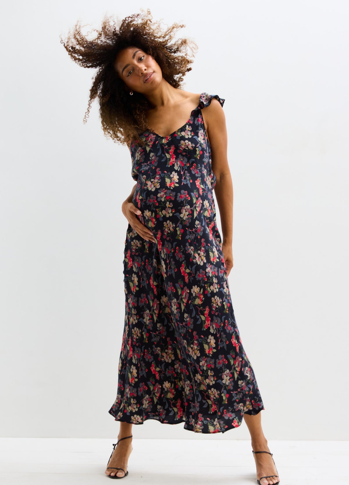 Navy floral maternity maxi dress with ruffled straps and empire waist.