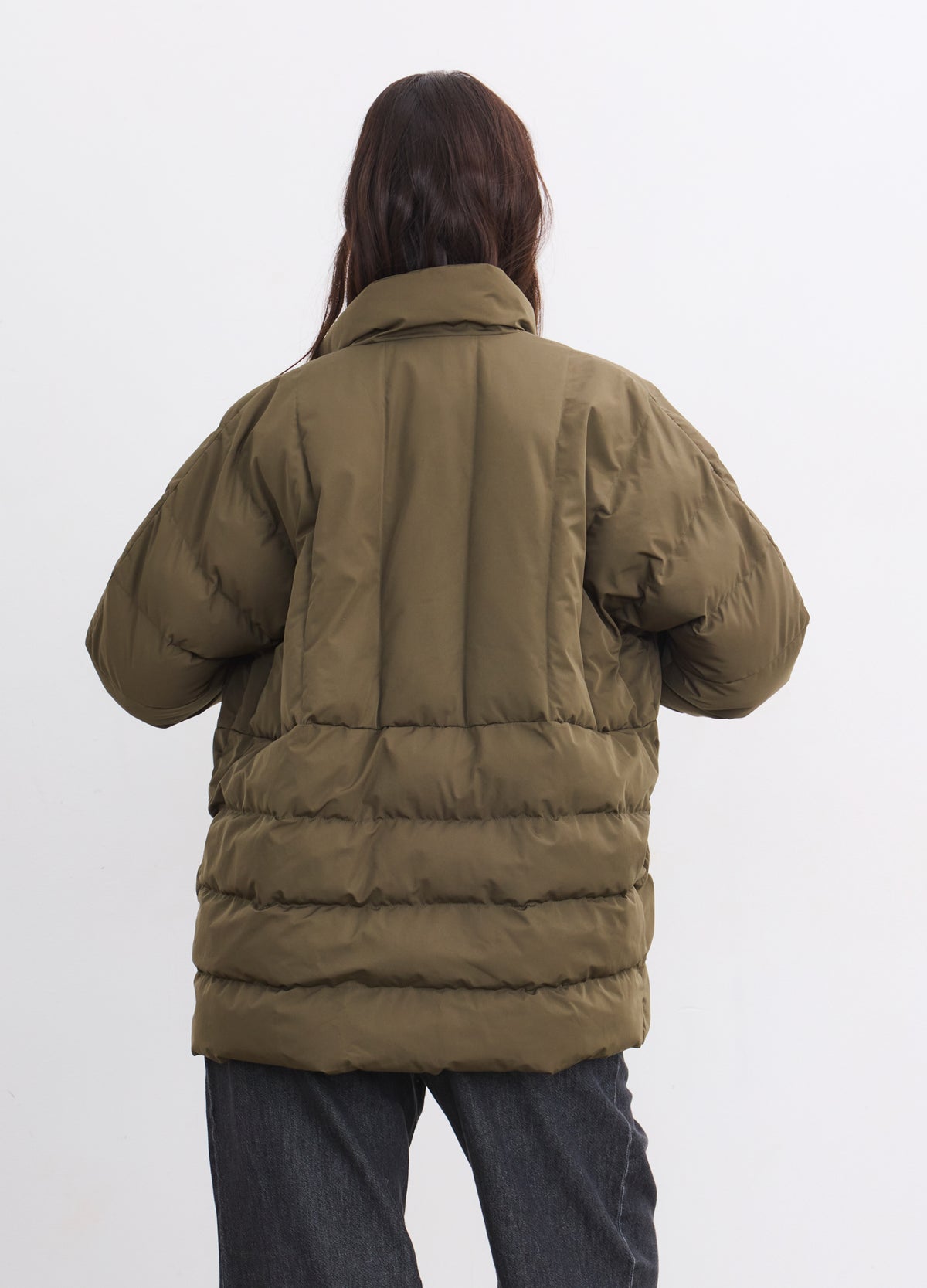 Olive green maternity puffer jacket with quilted sections and a high collar, shown from back.