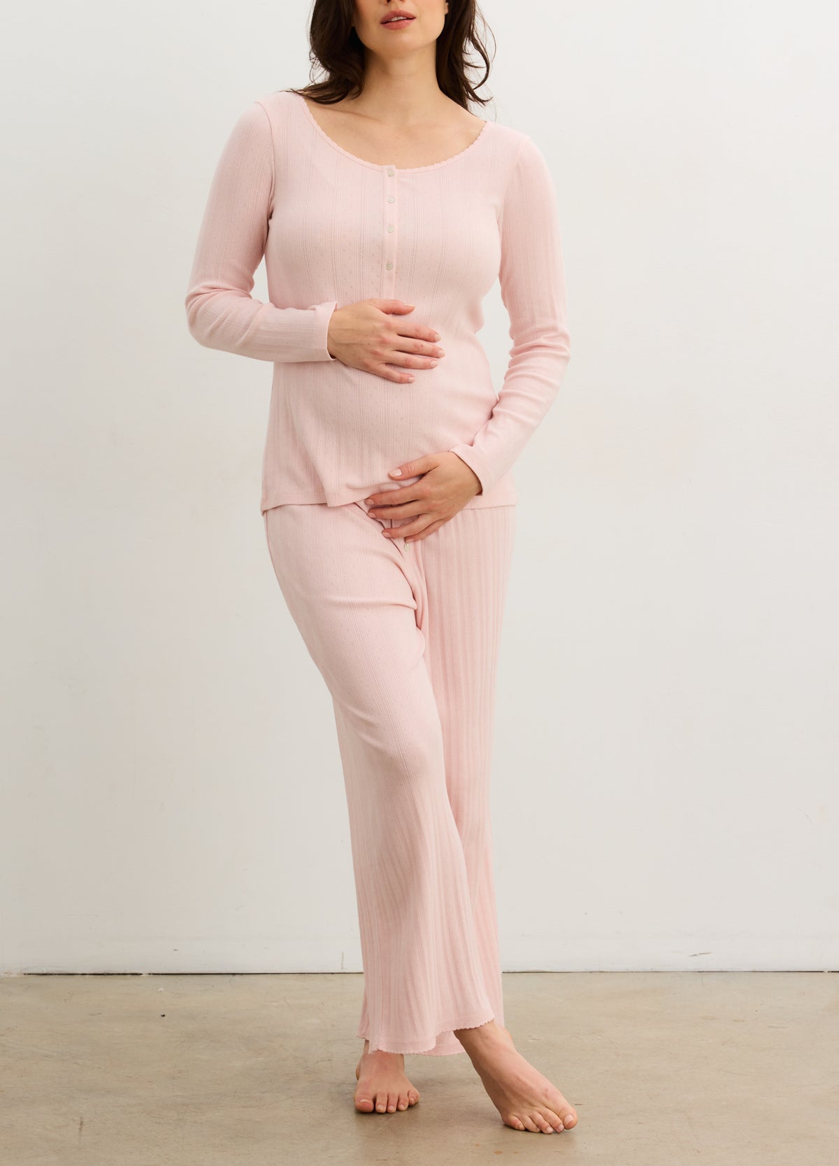 Soft pink ribbed long-sleeve henley top with button placket, paired with matching lounge pants.