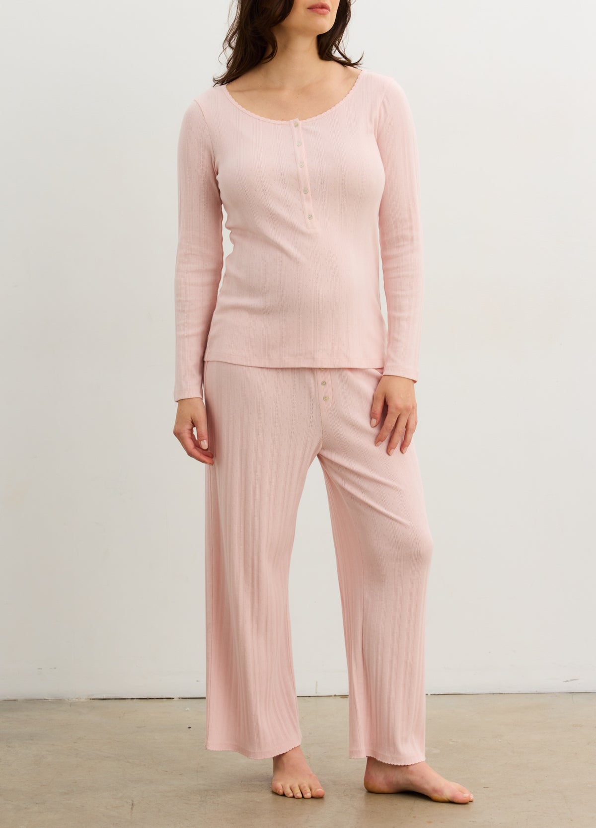 Soft pink ribbed knit long sleeve Henley top paired with matching wide-leg maternity loungewear pants.