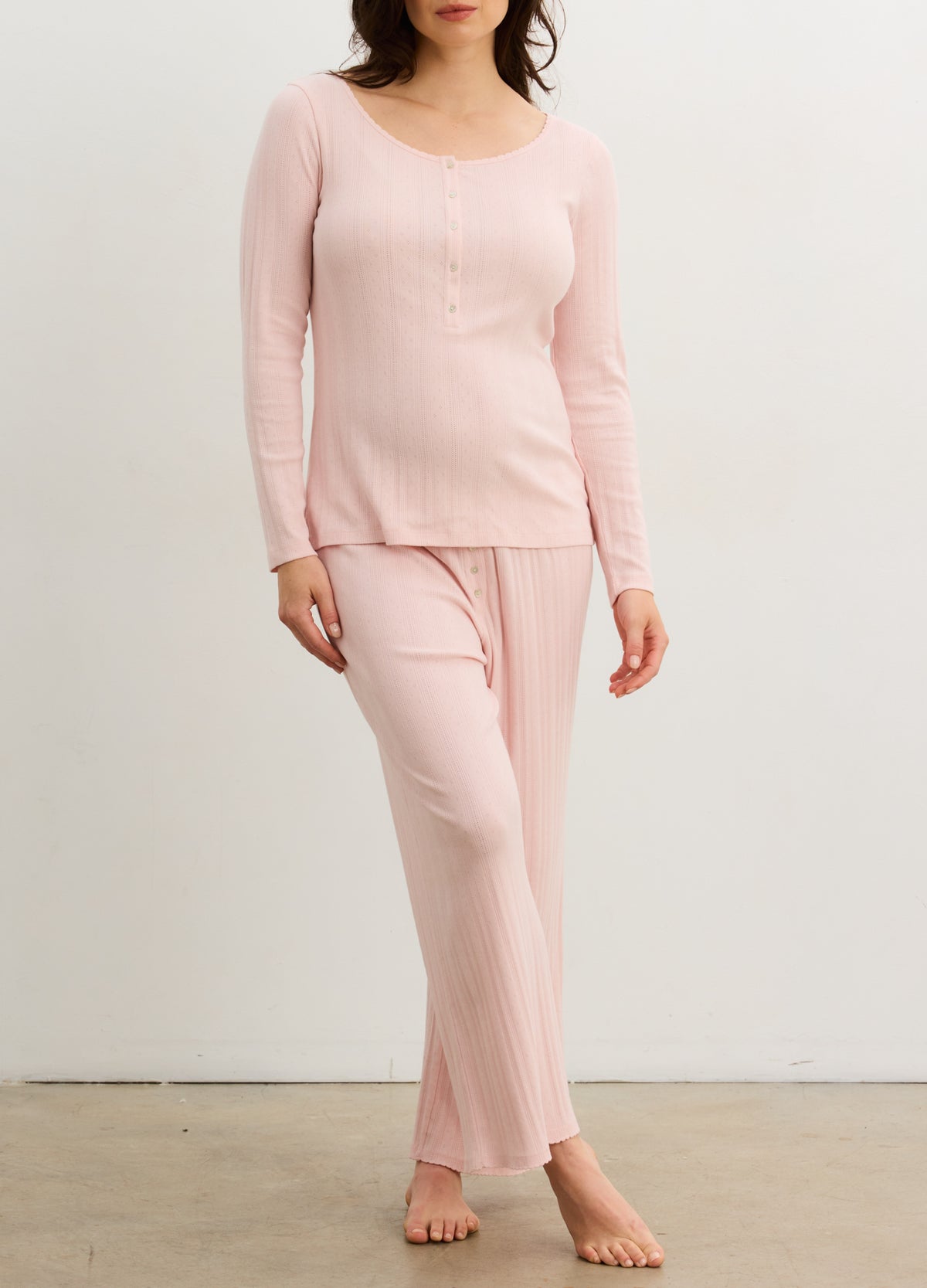 Soft pink ribbed maternity lounge set with long-sleeve buttoned top and wide-leg pants.