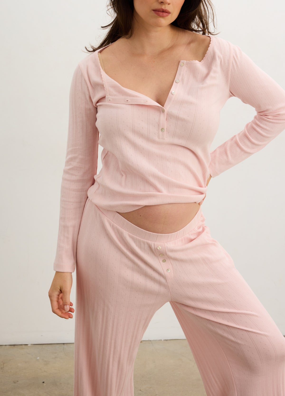 Soft pink ribbed maternity lounge pants with wide waistband, designed for 4th trimester comfort.