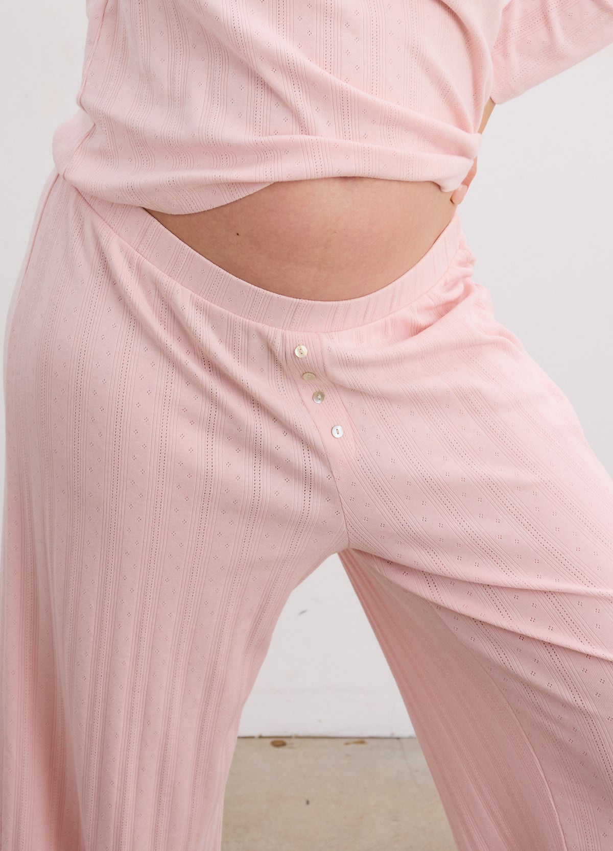 Soft pink ribbed maternity pants with a stretchy waistband designed for postpartum comfort.