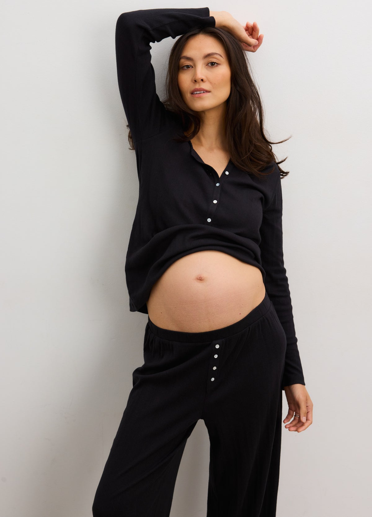 Black soft knit maternity loungewear set with long-sleeve henley top and fitted pointelle pants designed for postpartum.