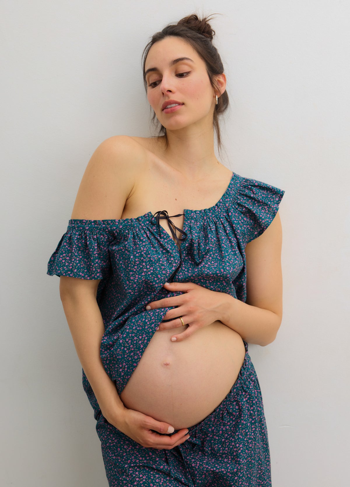 Navy blue one-shoulder maternity tank with ruffled neckline and small floral print.