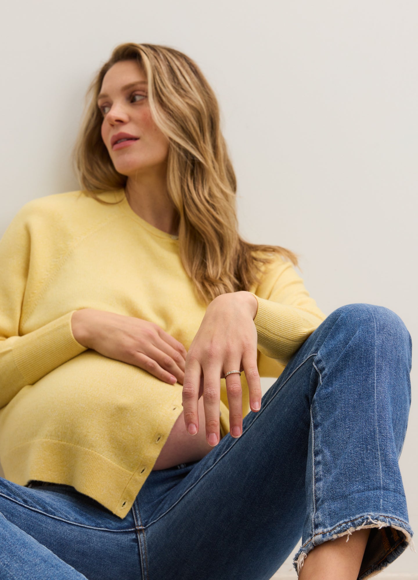 Soft yellow maternity cardigan with a relaxed fit, long sleeves, and a round neckline.