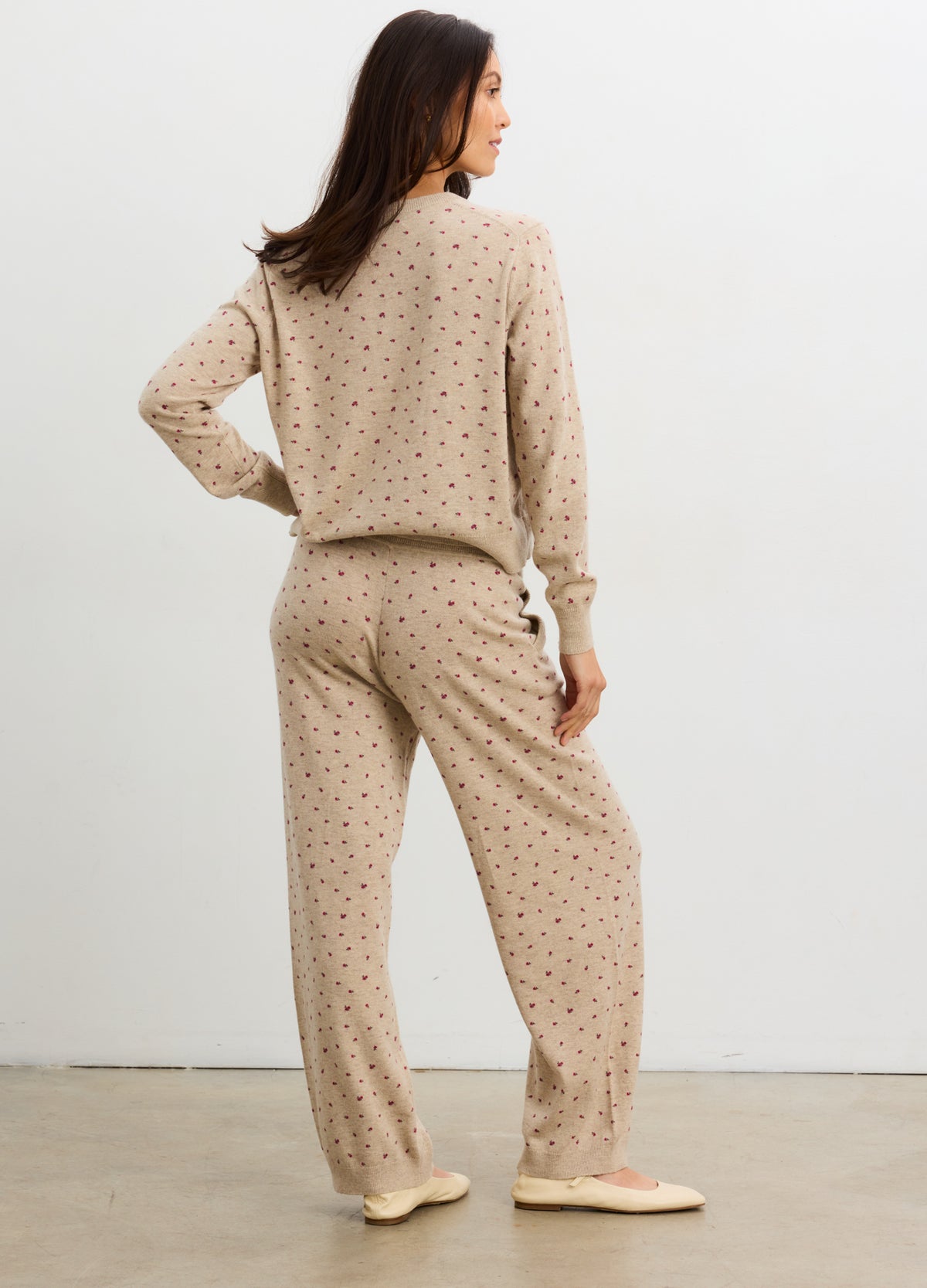 Beige knit maternity pants with small floral print, relaxed fit, and soft fabric.