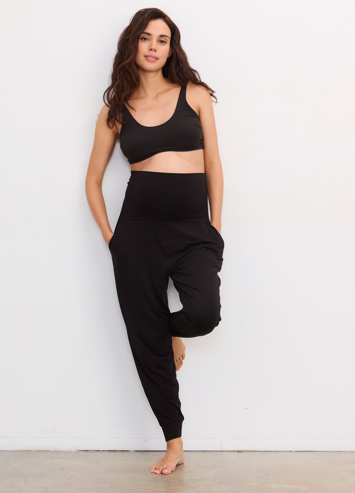 Black maternity lounge pants with a high elastic waistband and tapered legs.