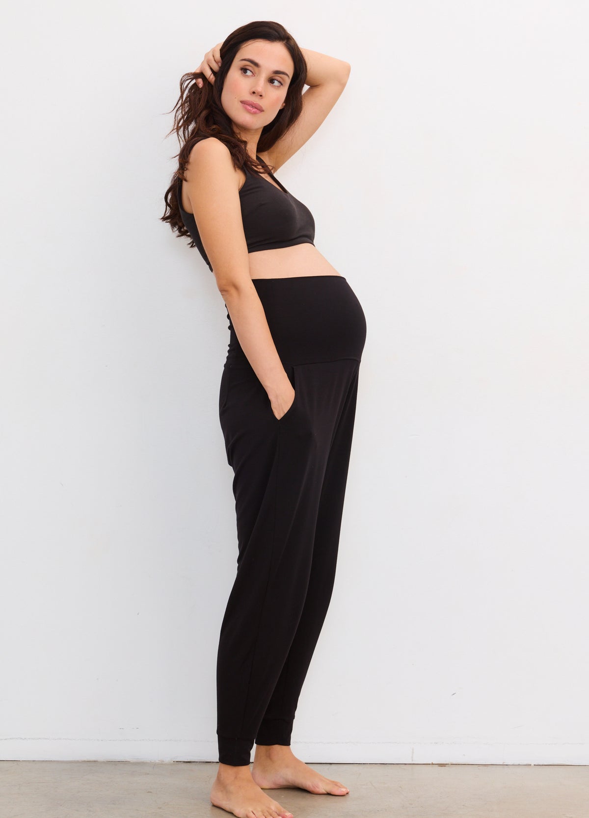 Black maternity lounge pants with a high stretchy waistband and tapered legs.