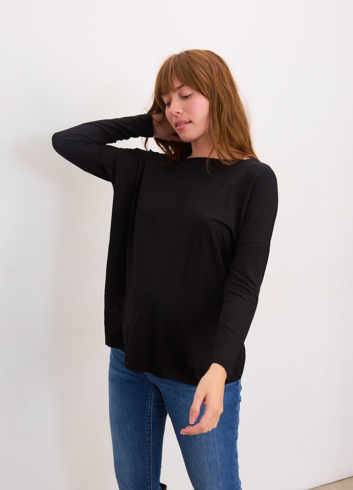 Black long-sleeve maternity tee with stretchy fabric and relaxed fit for pregnant comfort.