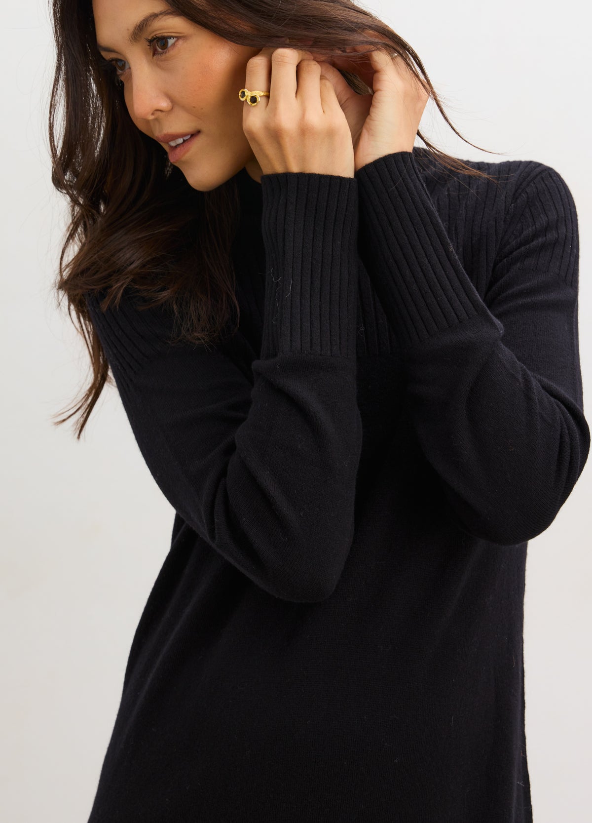 Black ribbed knit mockneck sweater dress with long sleeves, designed for maternity fit.