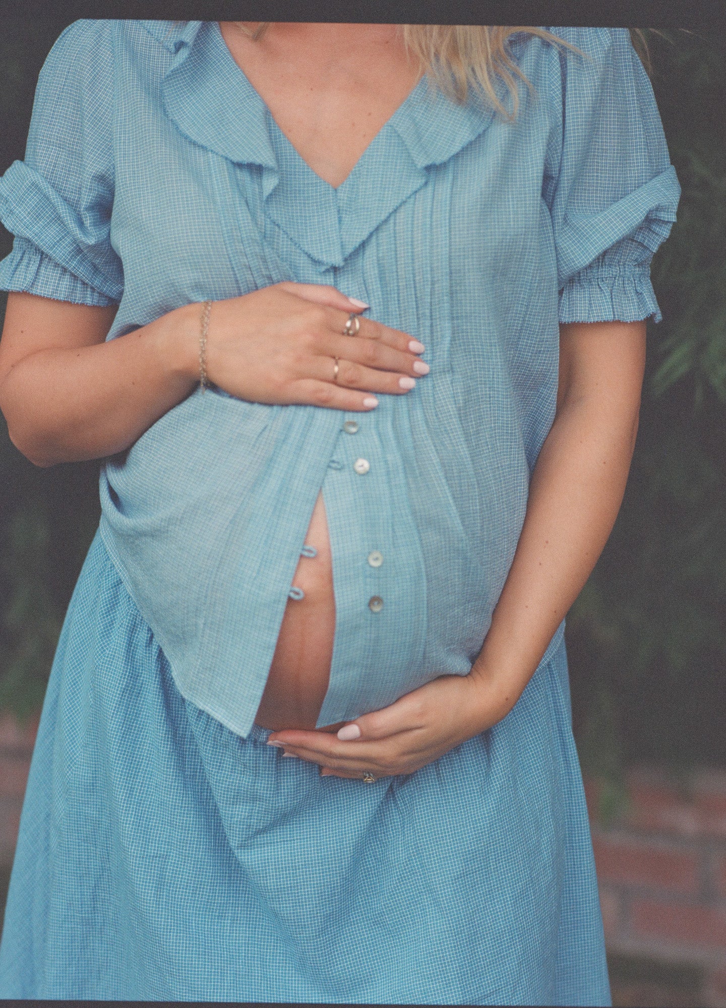 Light blue maternity nursing blouse with short puff sleeves and buttons down front.