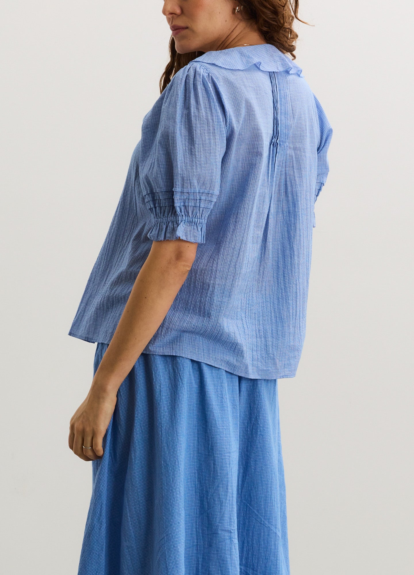 Light blue maternity nursing blouse with elbow-length puff sleeves and loose fit.