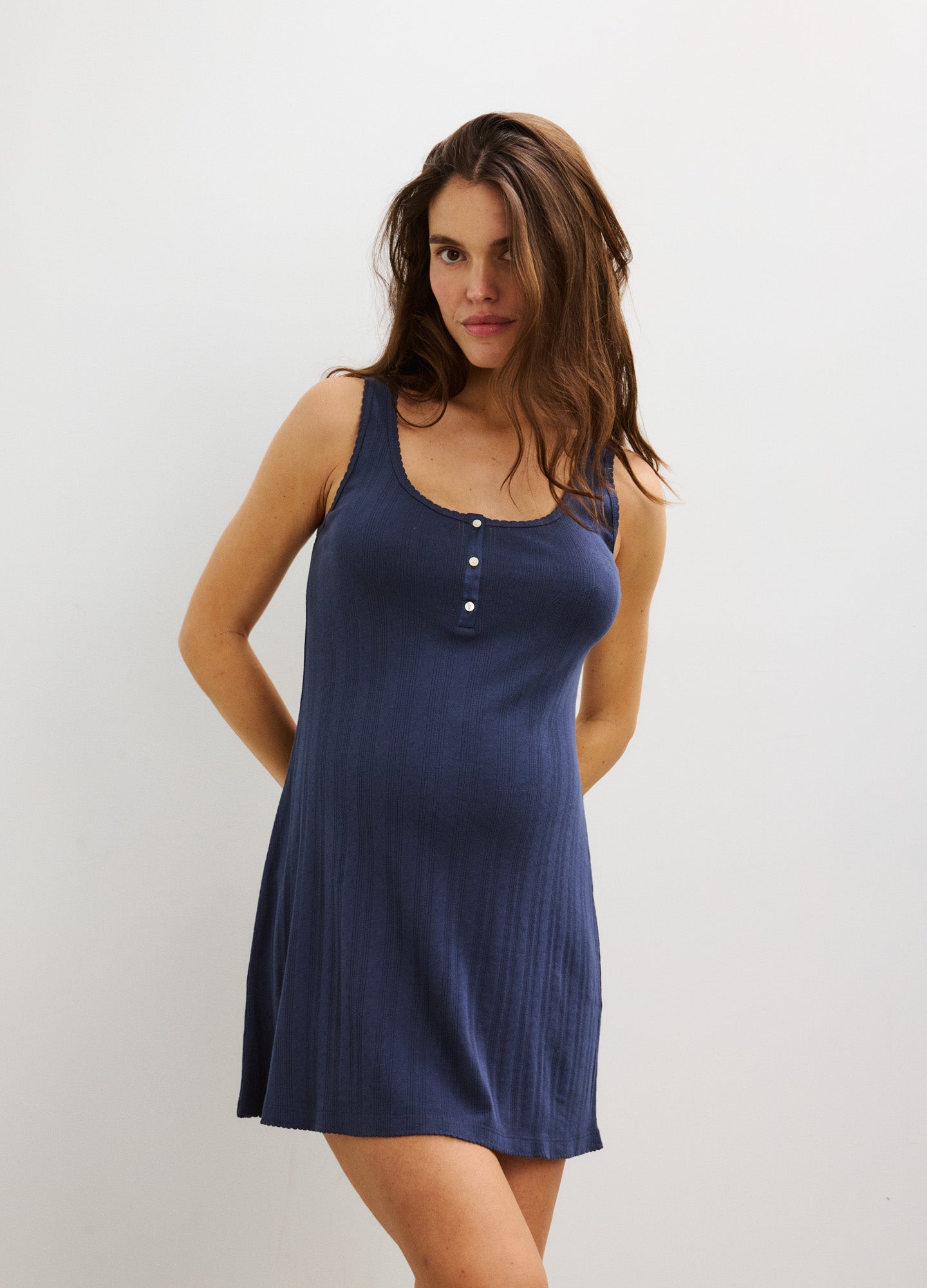 Navy blue sleeveless maternity nightie with scoop neck and button detail, soft knit fabric.