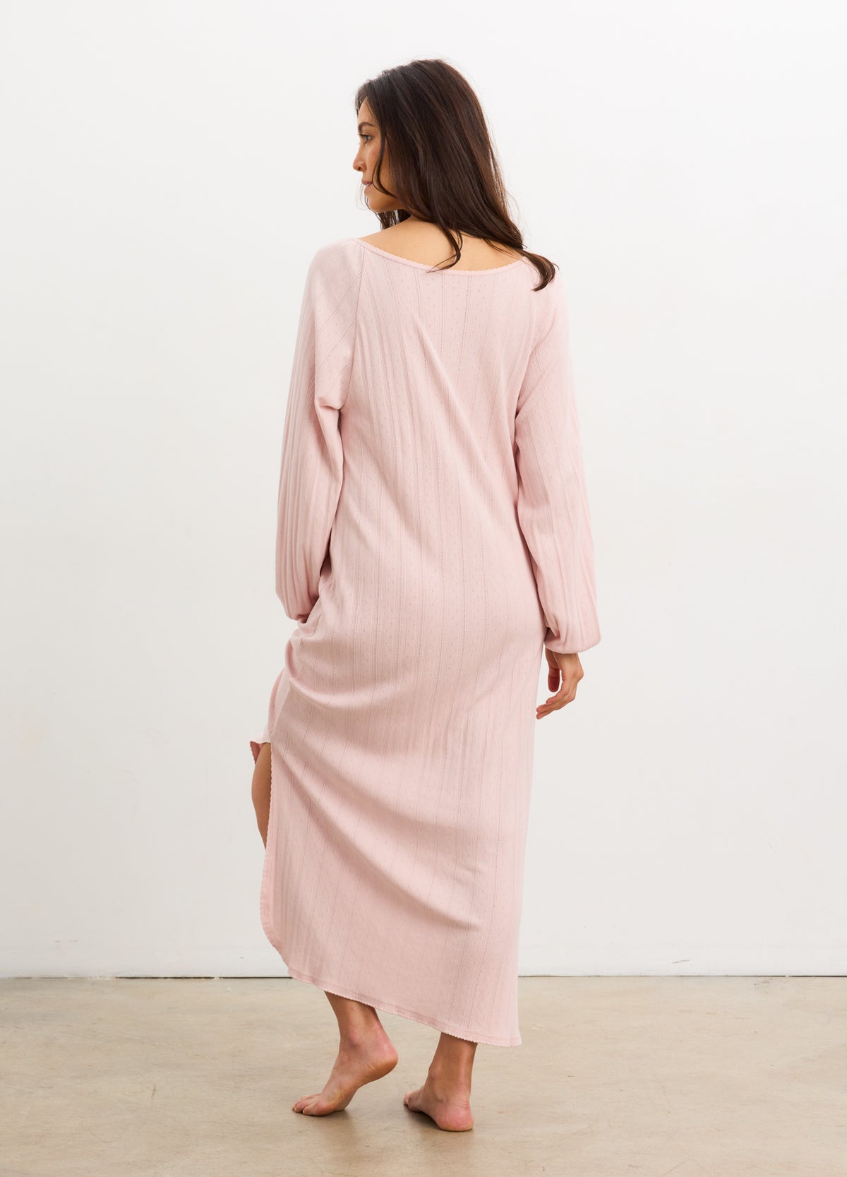 Light pink ribbed long sleeve nightgown with pointelle detailing and side slit, mid-calf length.