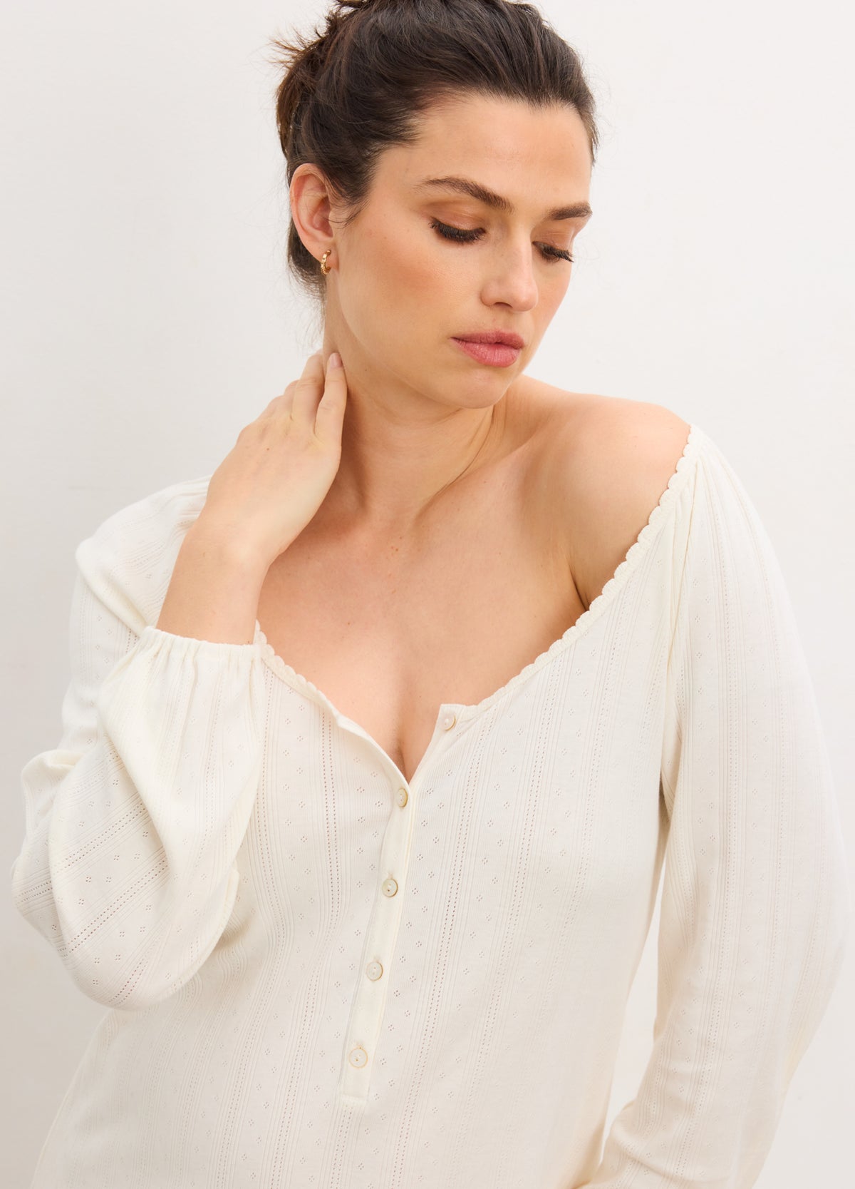 Cream-colored long sleeve nightgown with delicate pointelle knit, front button placket, and soft ribbed fabric.