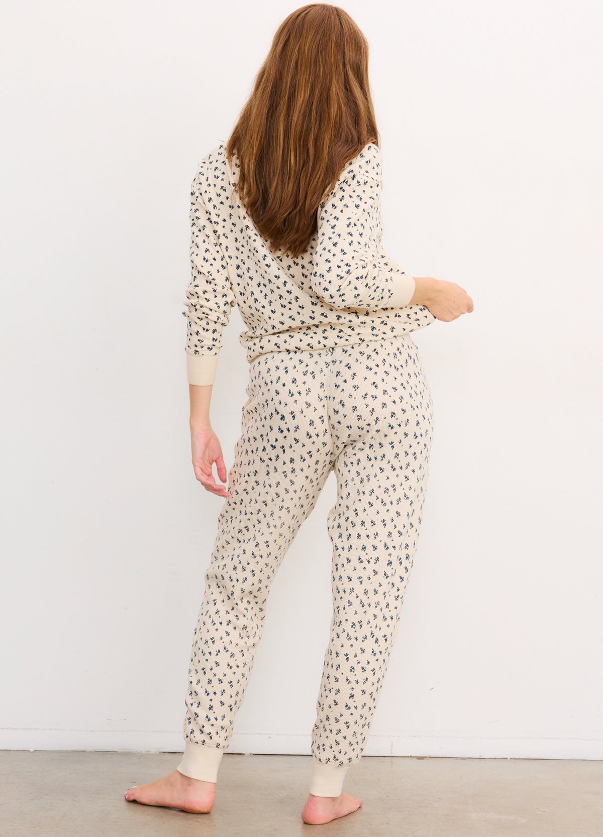 Light beige waffle knit jogger pants with small black printed spots, relaxed fit and elastic cuffs, styled for maternity.