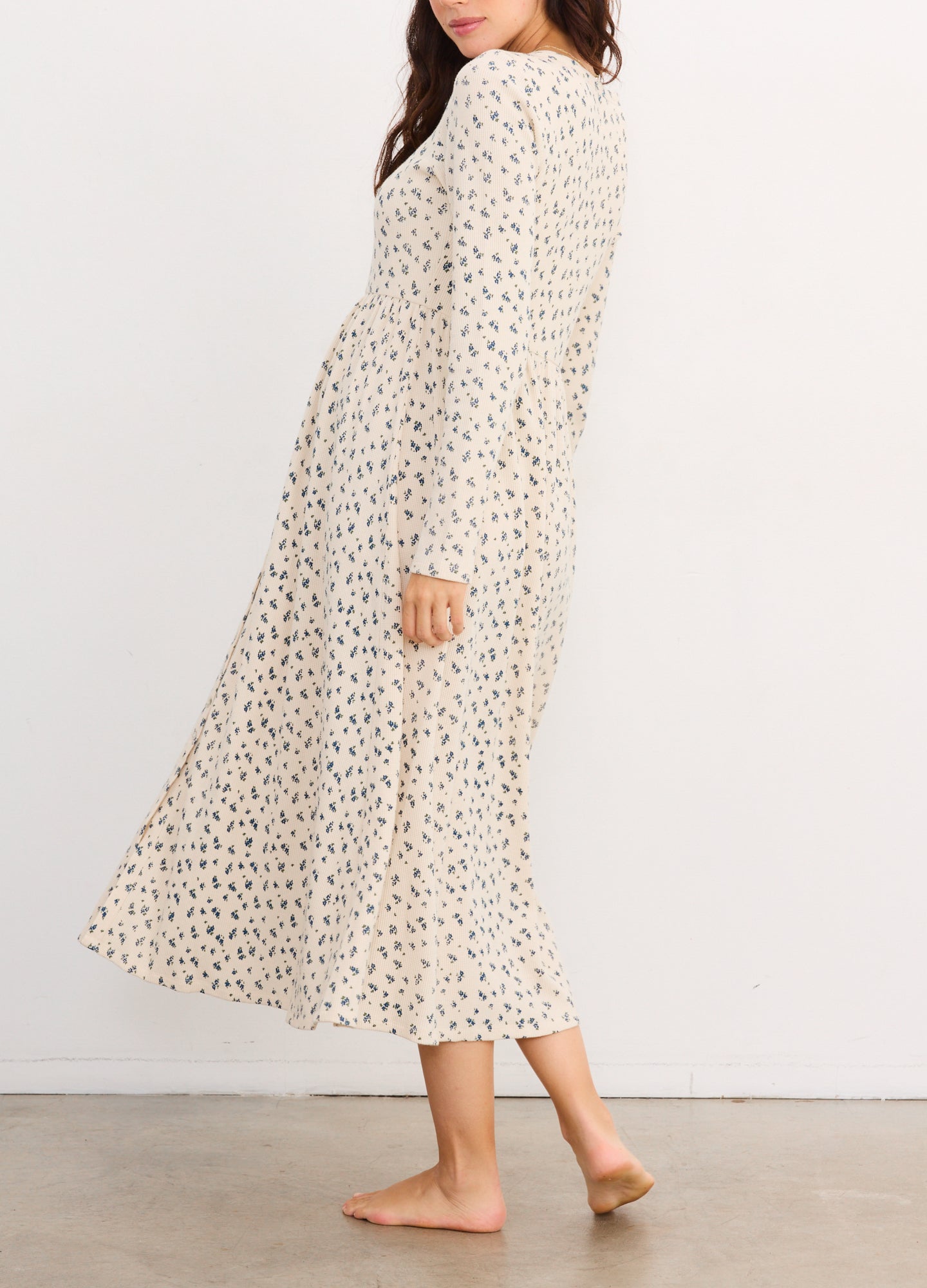 Cream waffle-knit nursing dress with small floral print, long sleeves, and midi length.