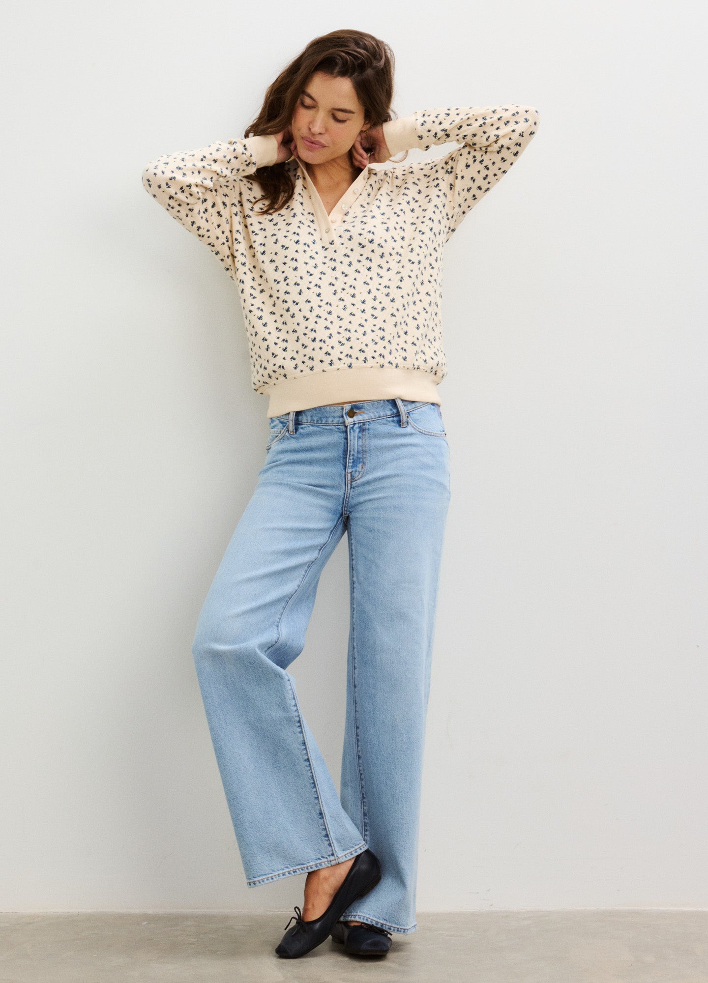 Cream waffle knit pullover with black abstract print, relaxed fit, and V-neck styling.