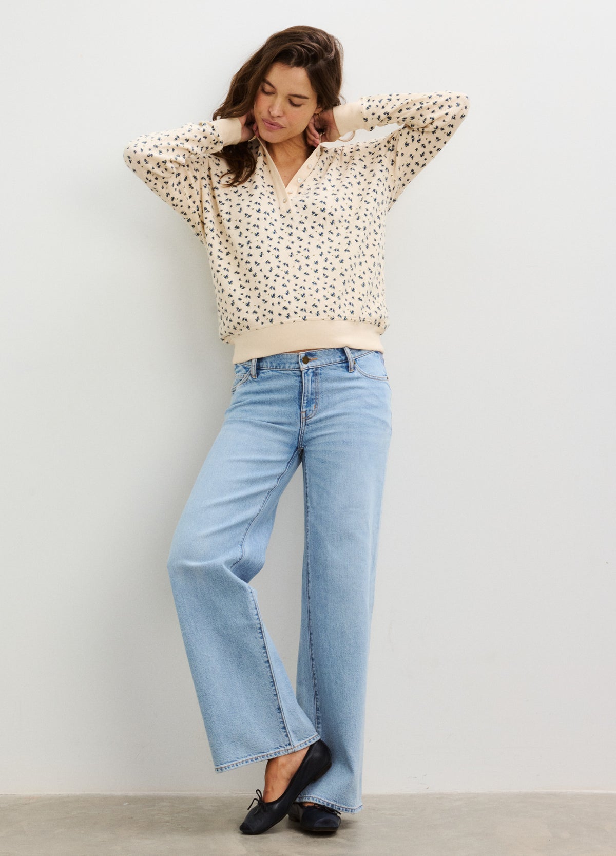 Cream waffle knit pullover with black abstract print, relaxed fit, and V-neck styling.