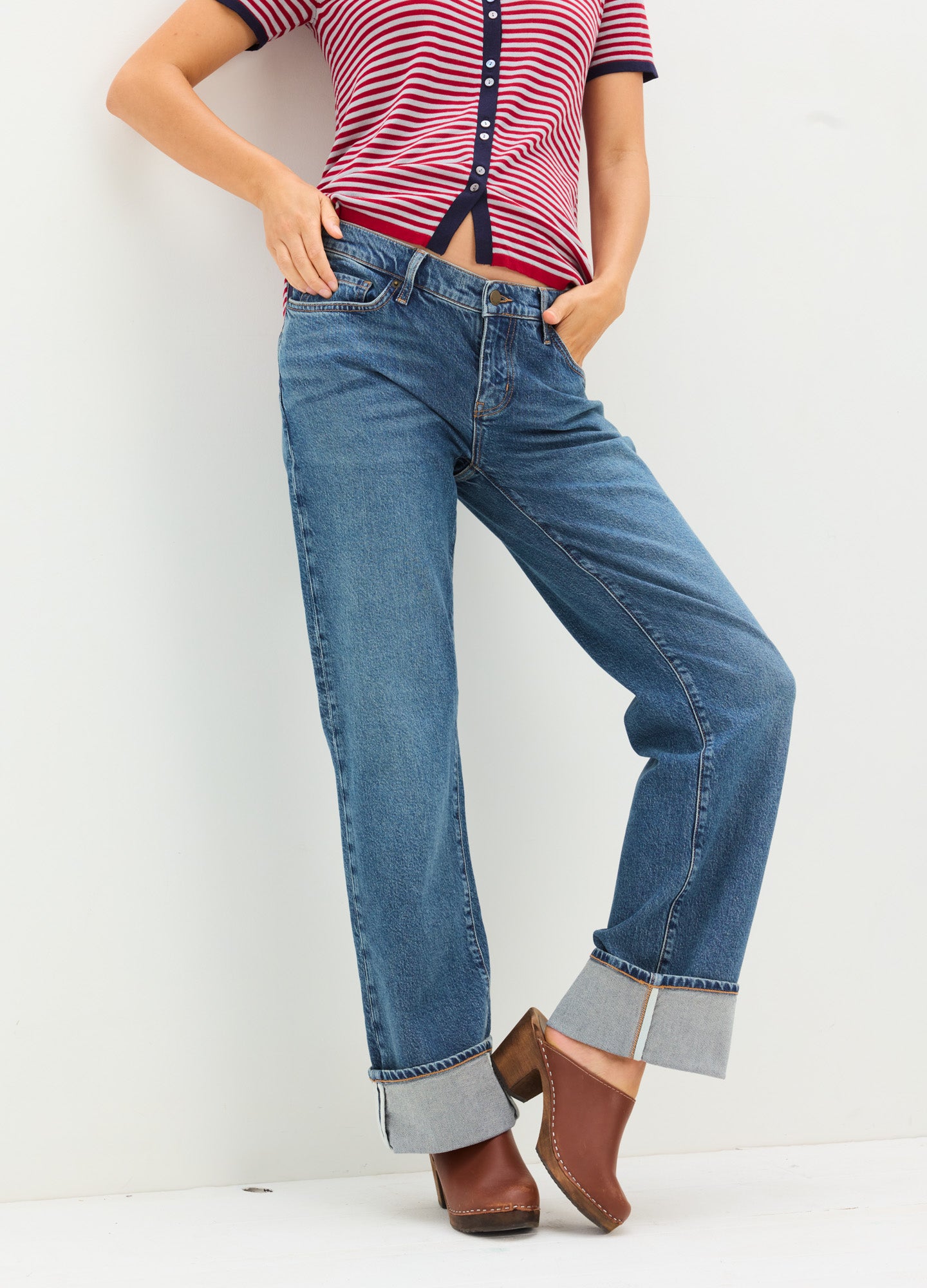 Blue relaxed fit maternity jeans with cuffed hems and stretchy waistband, worn with brown ankle boots.
