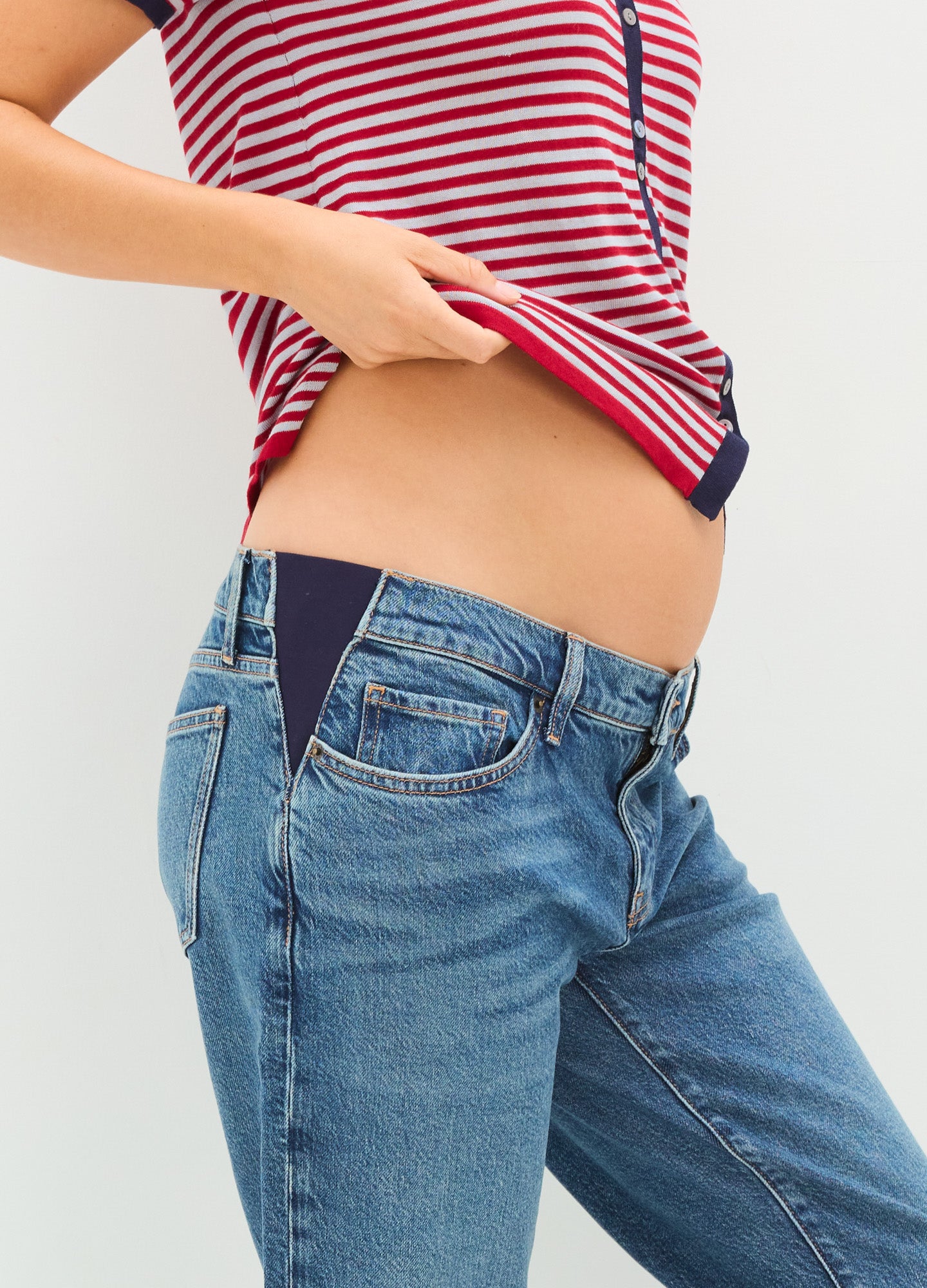 Light blue denim maternity jeans with cuffed hems and stretchy side panels for pregnant belly comfort.