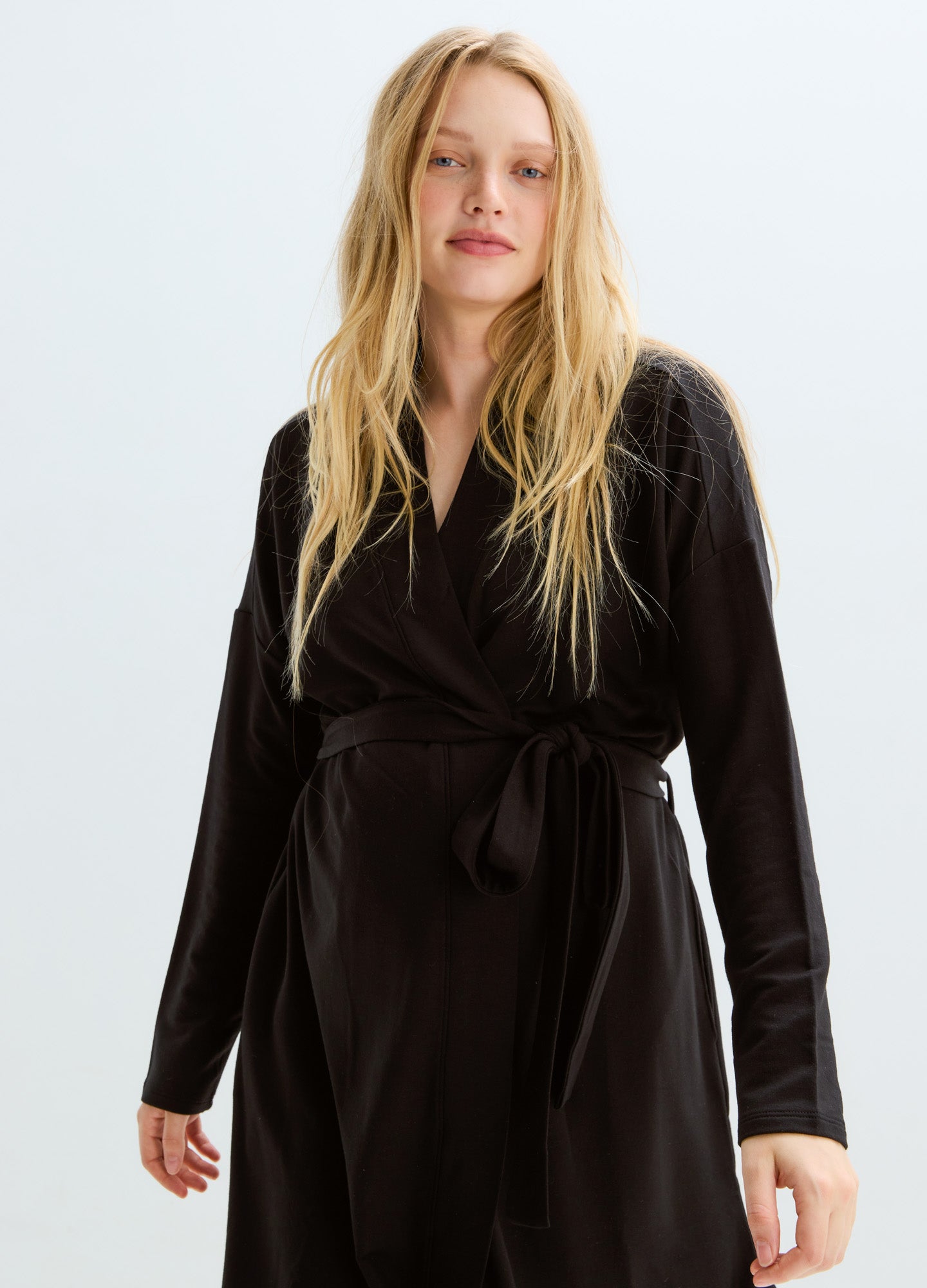 Black long-sleeve maternity robe with a waist tie and soft, cozy fabric.