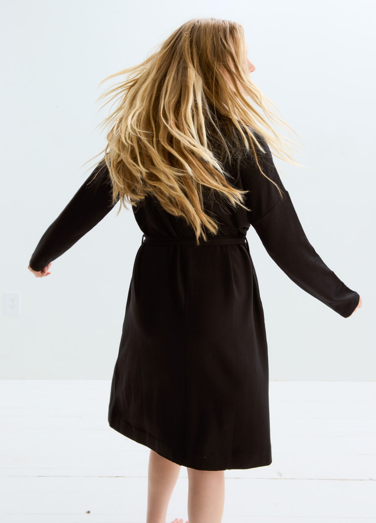 Black maternity robe with long sleeves and knee-length hem, soft flowy fabric.