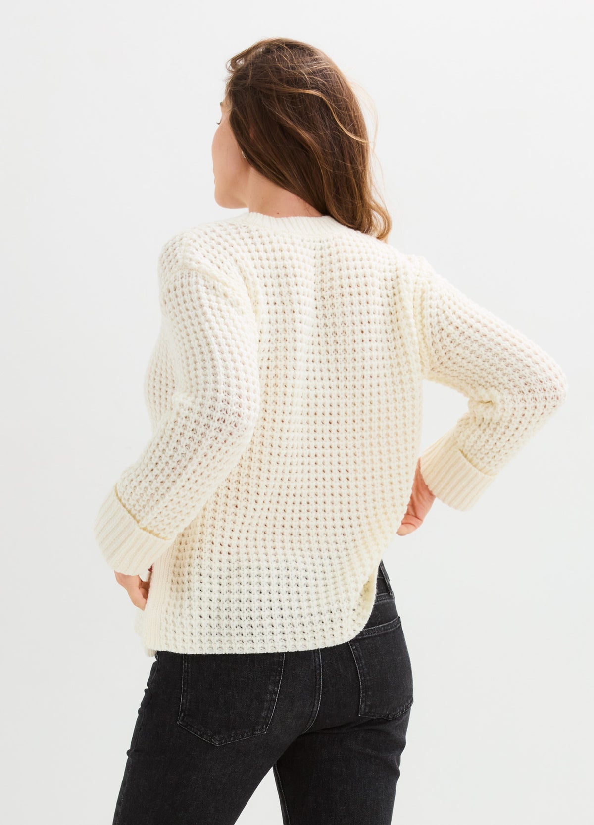 Cream waffle-knit sweater with a relaxed fit, ribbed cuffs and hem, shown from the back.