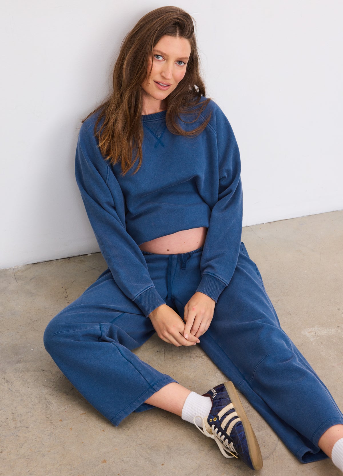 Blue opal maternity sweatpants with darted front detail designed for pregnant women, styled with matching cropped sweatshirt.