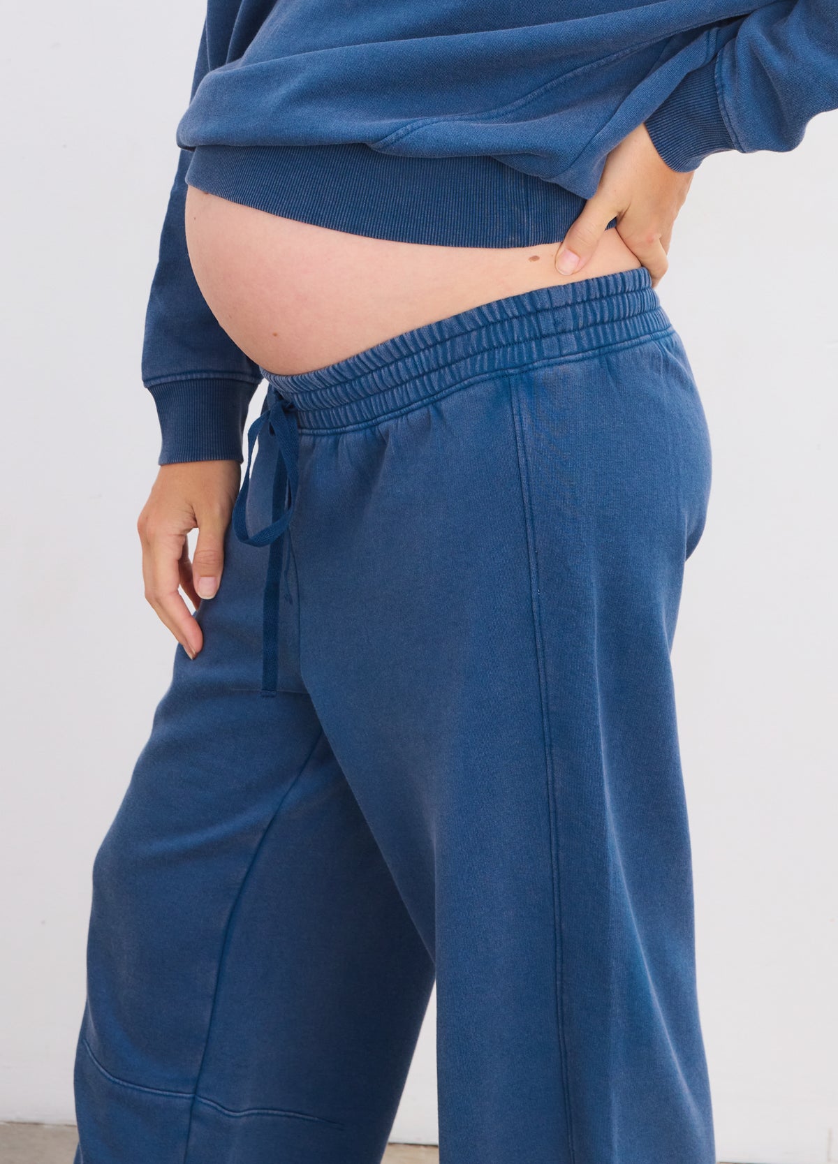 Navy blue maternity sweatpants with elastic waistband and relaxed fit, soft fabric.