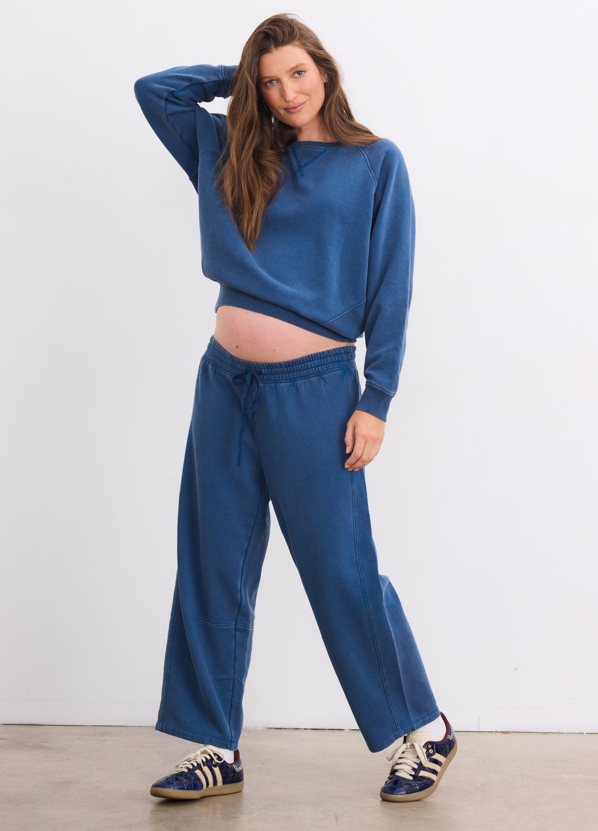 Blue Opal maternity sweatpants with darted design, soft fabric, worn by pregnant woman.