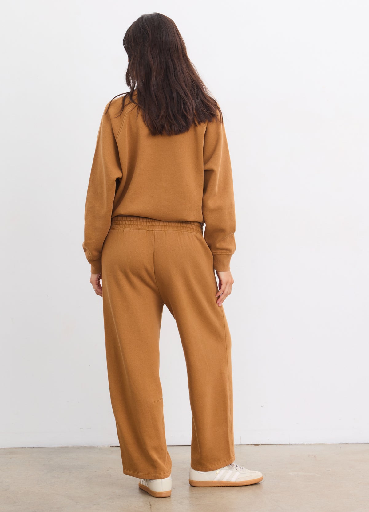 Brown relaxed-fit maternity sweatpants with darted details and elastic waistband.