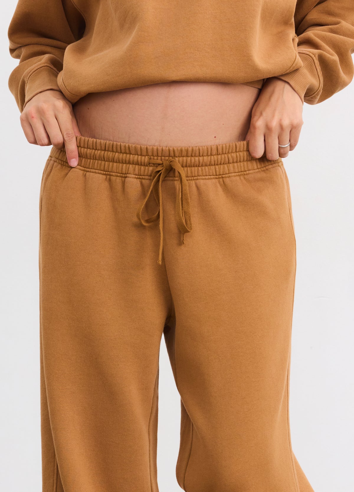 Brown maternity sweatpants with elastic waistband and adjustable drawstring, relaxed fit.