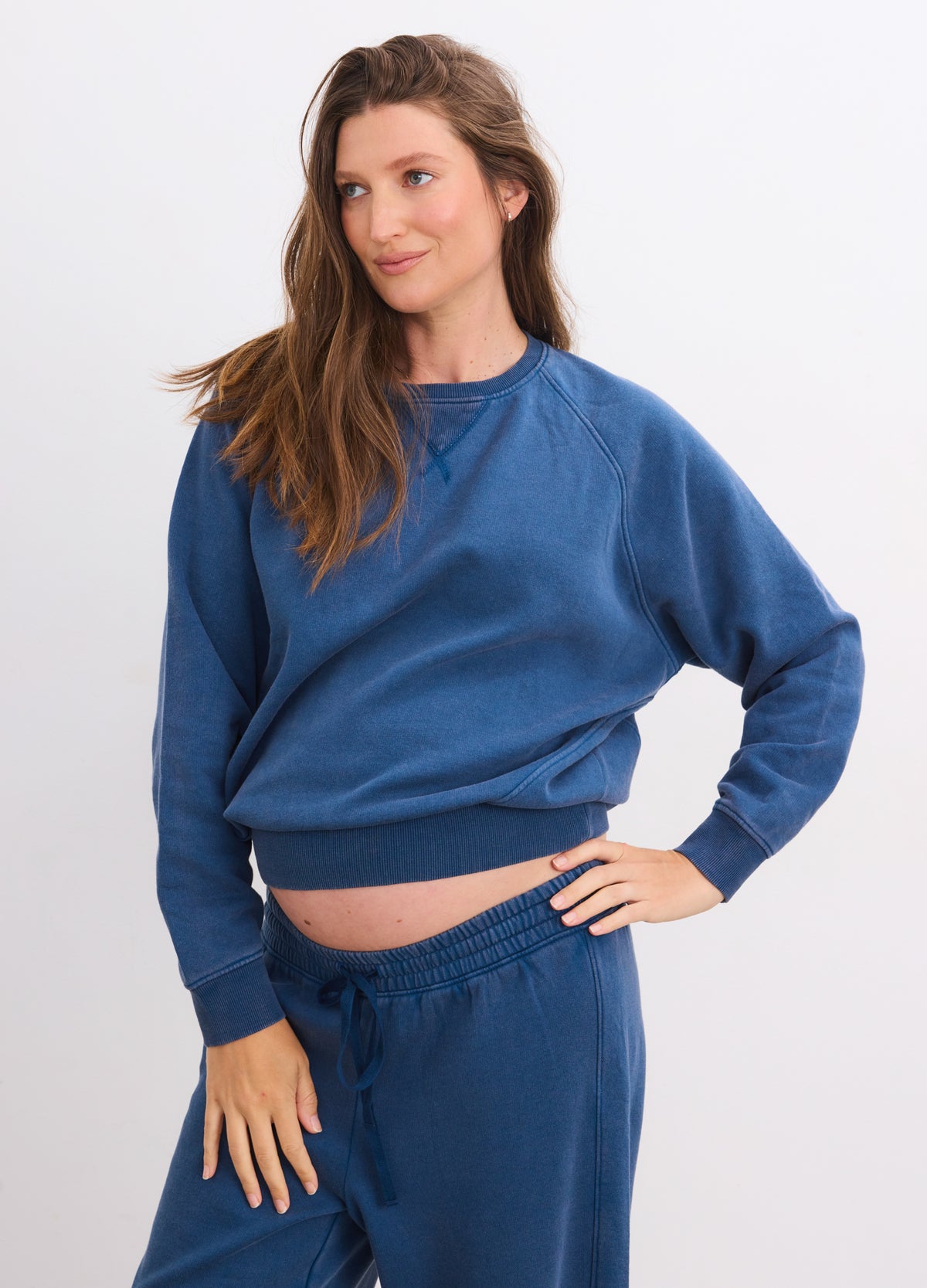 Blue Opal maternity sweatshirt with relaxed fit and ribbed cuffs on pregnant model.