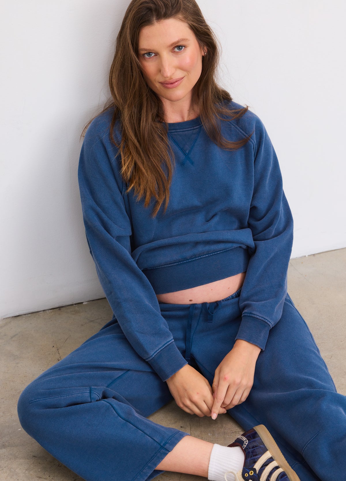 Blue maternity pullover sweatshirt with relaxed fit and ribbed cuffs, paired with matching sweatpants.