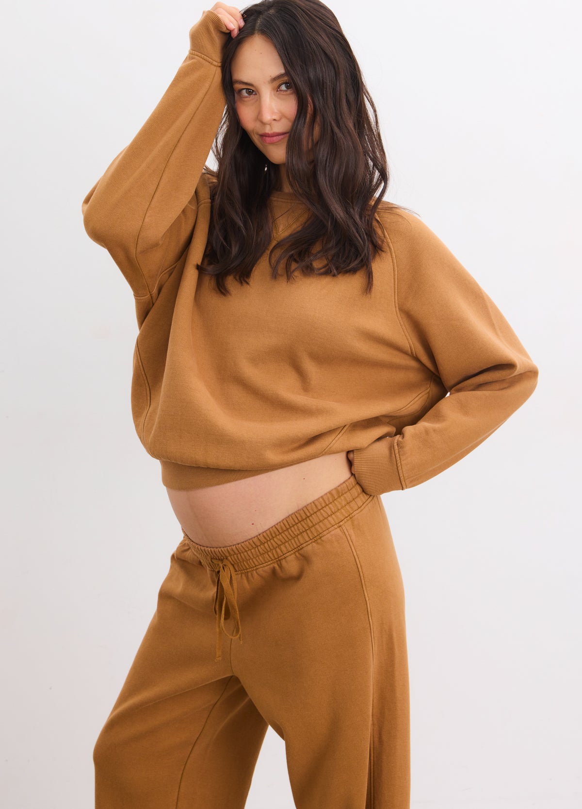 Maternity rubber-colored pullover sweatshirt with relaxed fit on pregnant model.