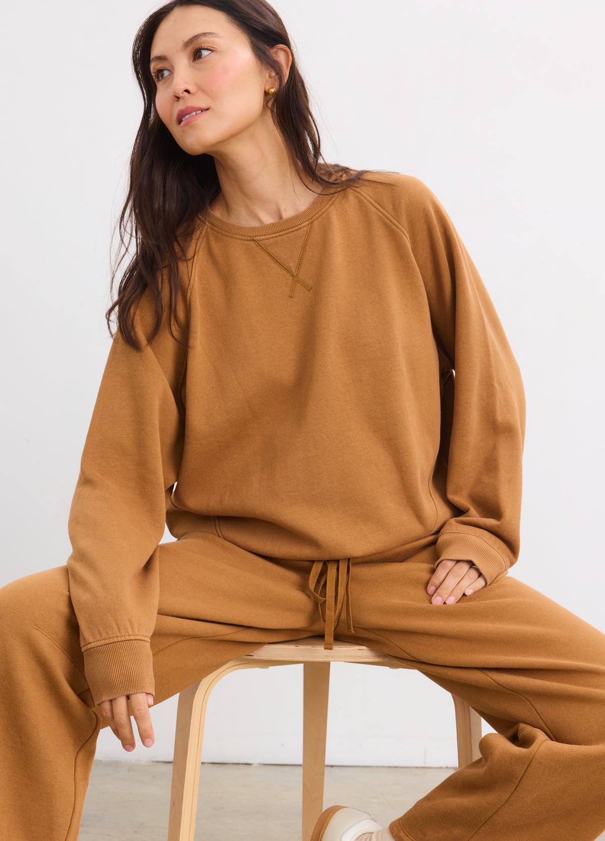 Camel brown maternity pullover sweatshirt with relaxed fit and ribbed cuffs, paired with matching drawstring pants.