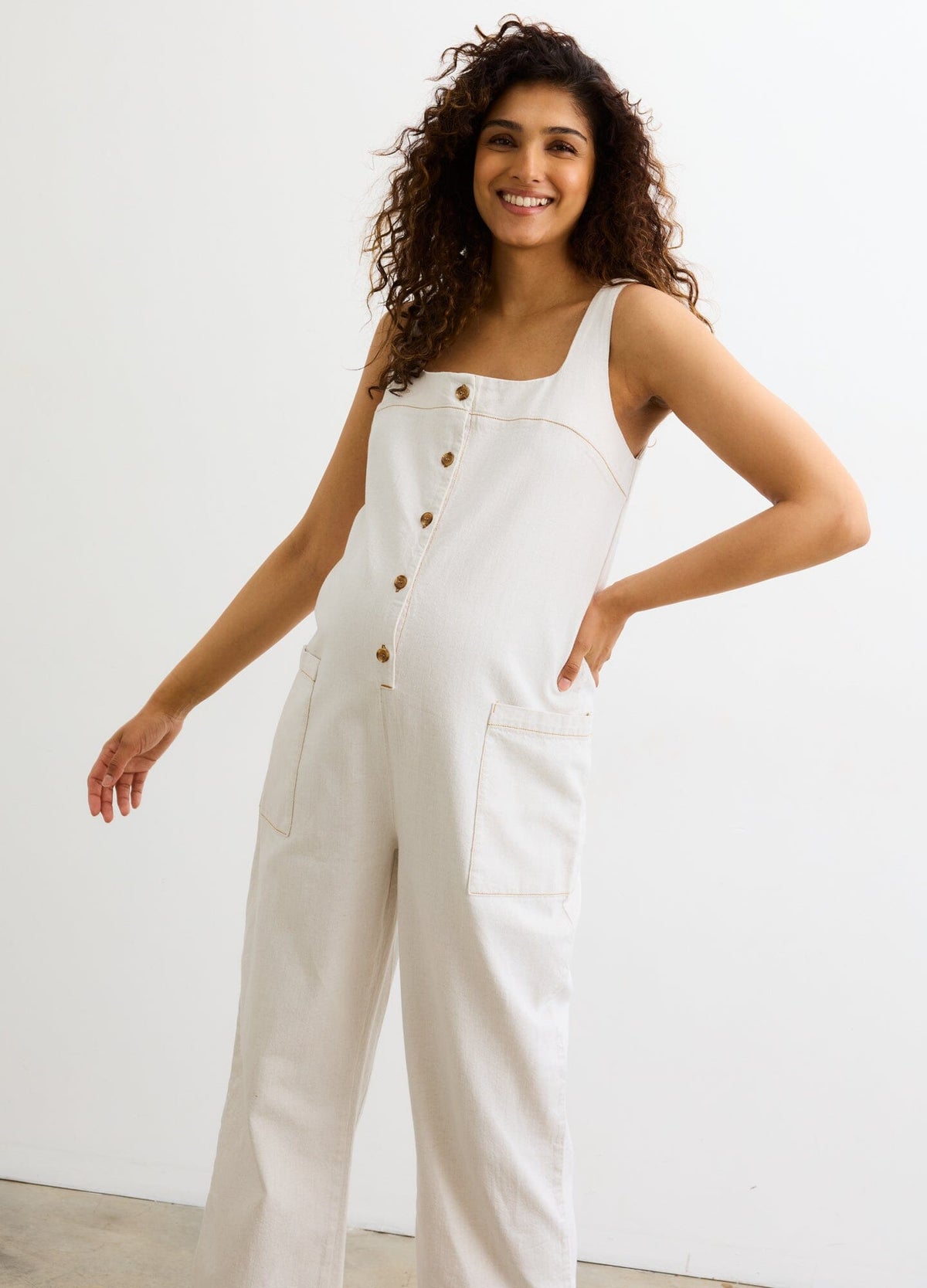 The Ryland Jumper - Chalk-colored maternity jumper with front buttons and wide straps, styled for nursing and postpartum comfort.