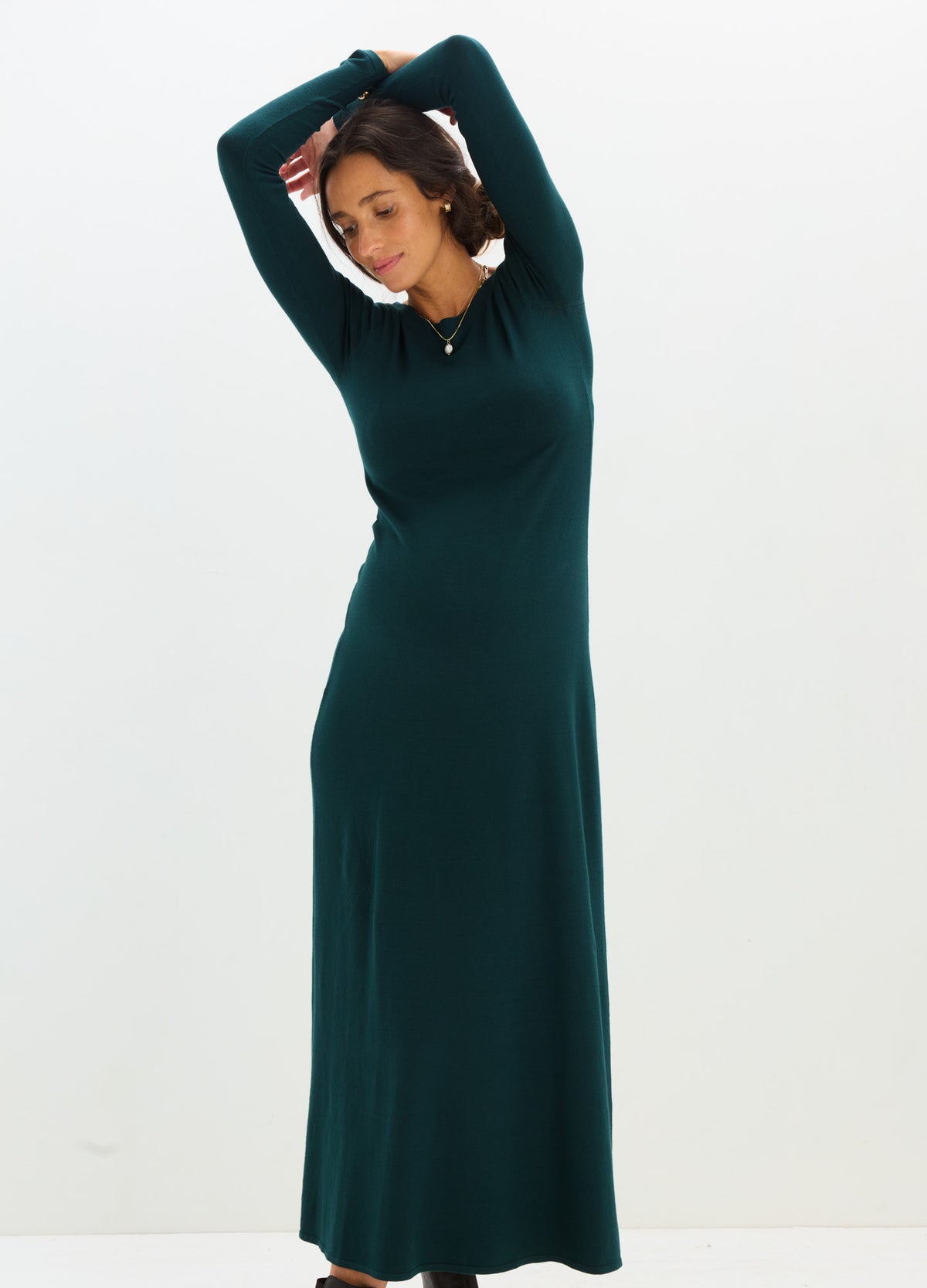 Dark green long-sleeve knit maternity dress with fitted silhouette and soft stretch fabric.